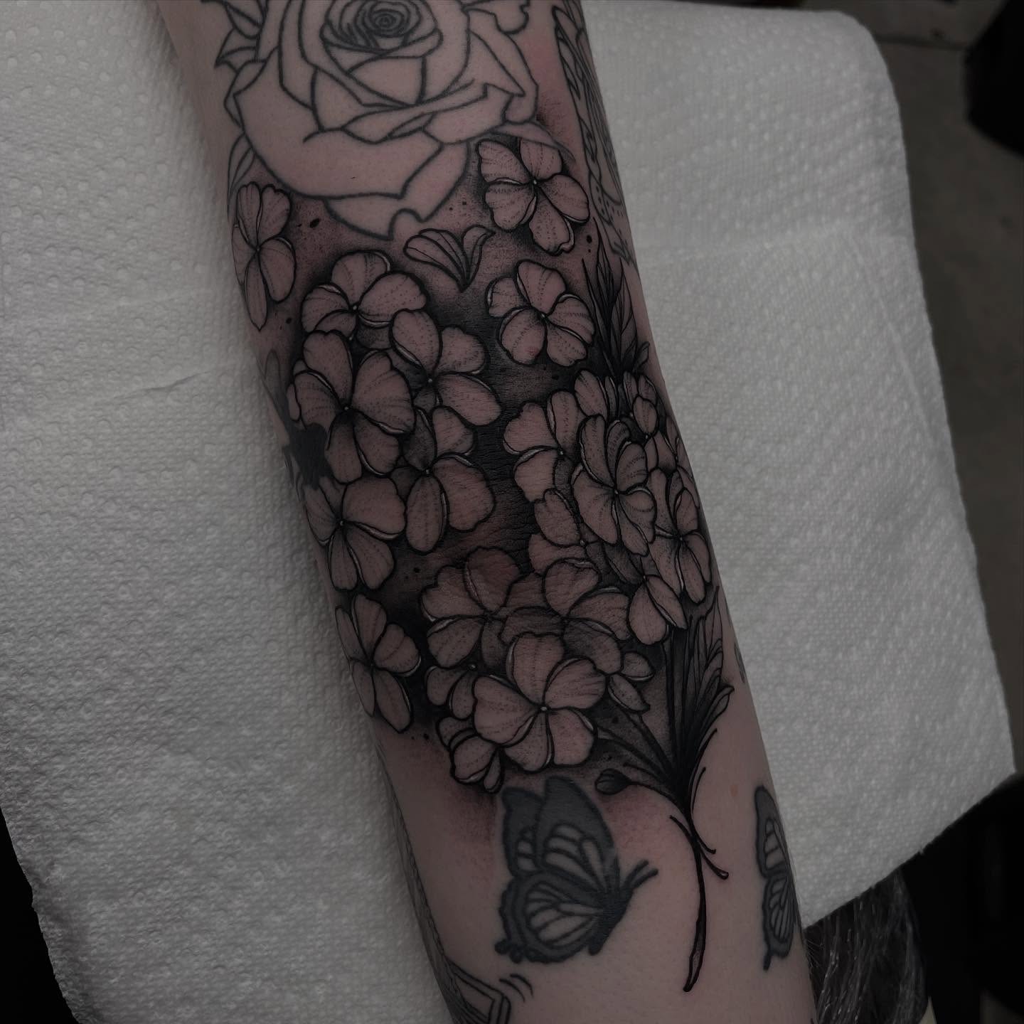 Flowers and butterfly black and grey tattoo on the forearm by Brandon Mola, Chicago, Illinois