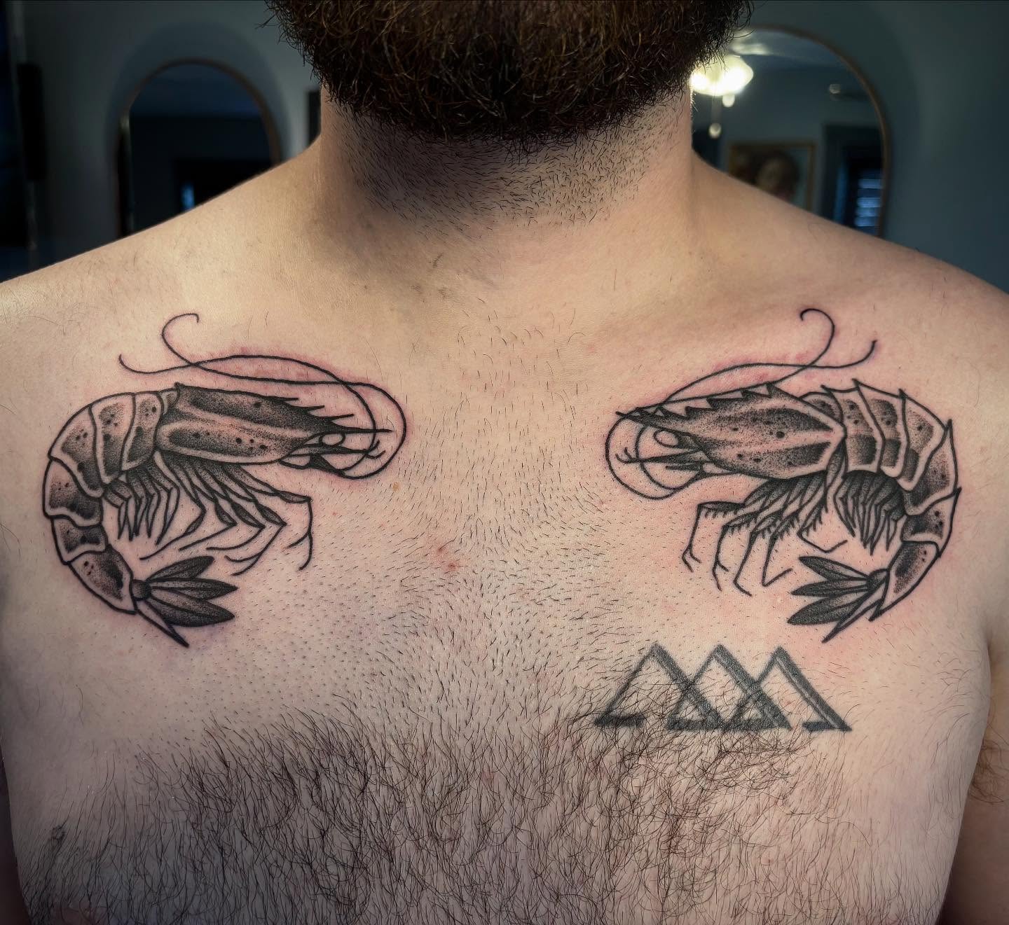 Lobster black and grey tattoo on the chest by Nolan Croteau