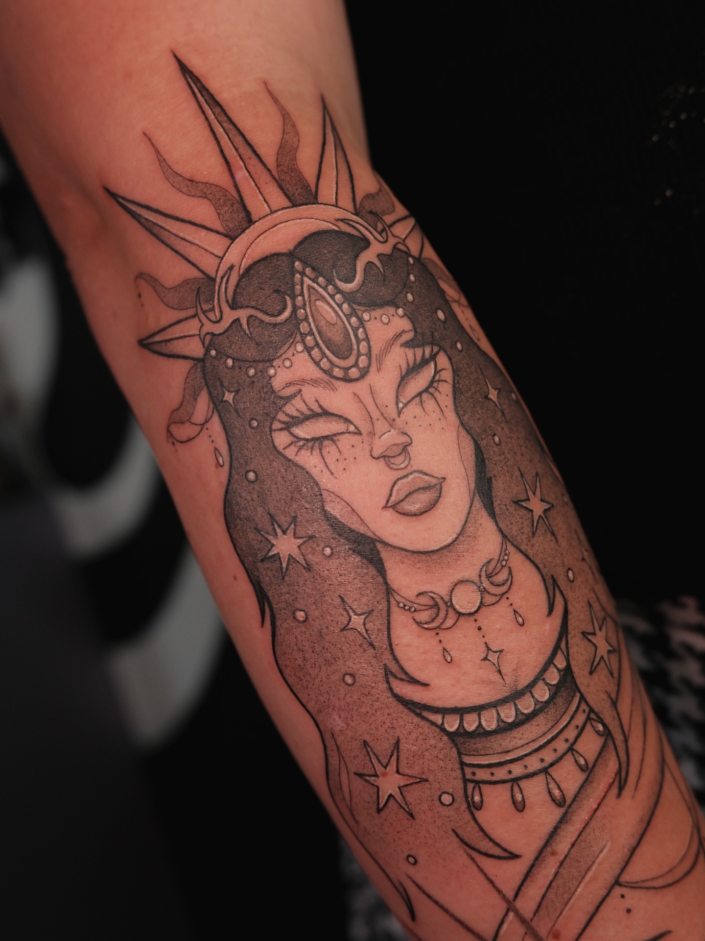 Woman with celestial theme realism tattoo on the forearm by Velvet, Seattle, Washington