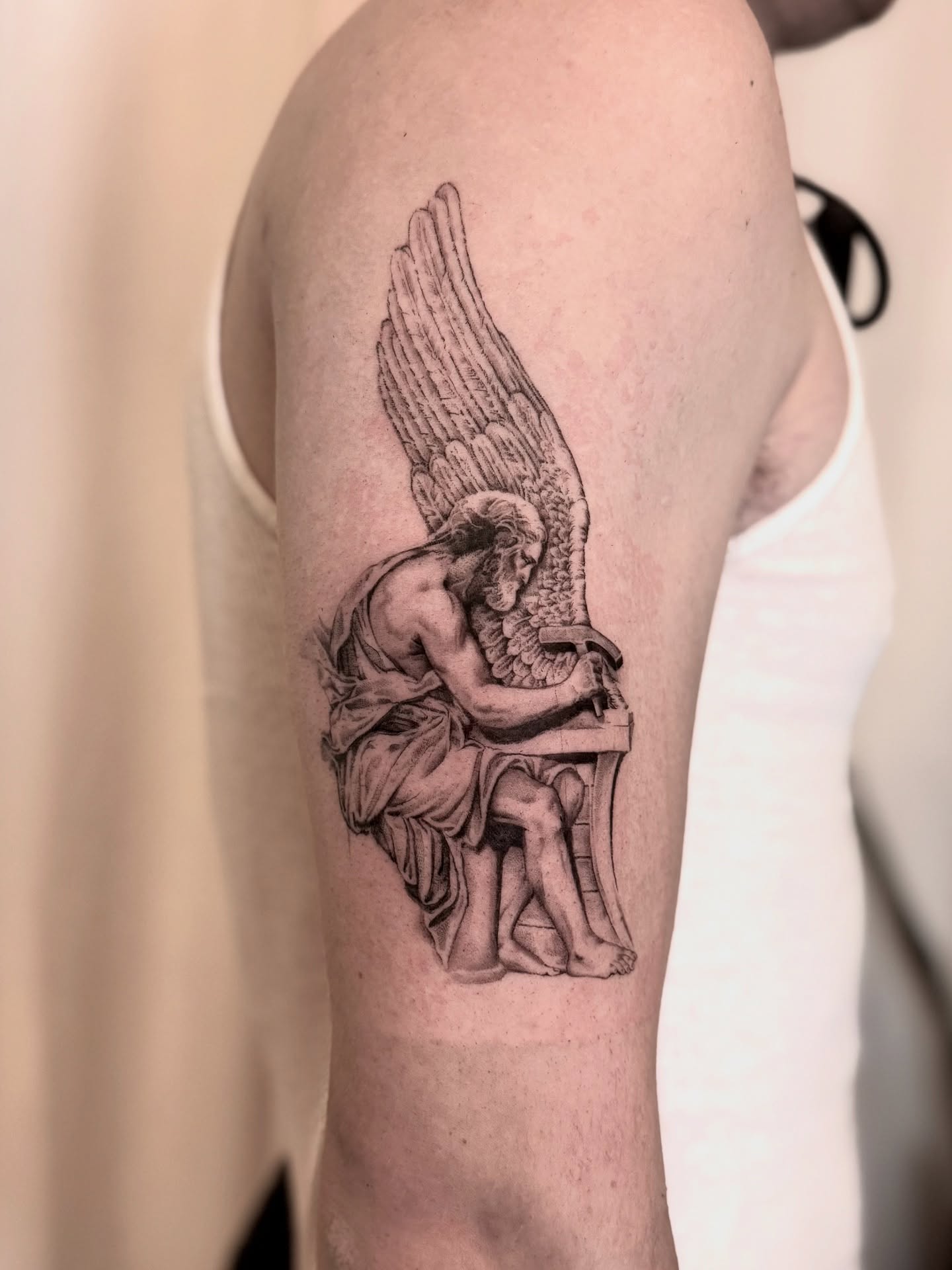 Wings and angel black and grey tattoo on the forearm by Oori