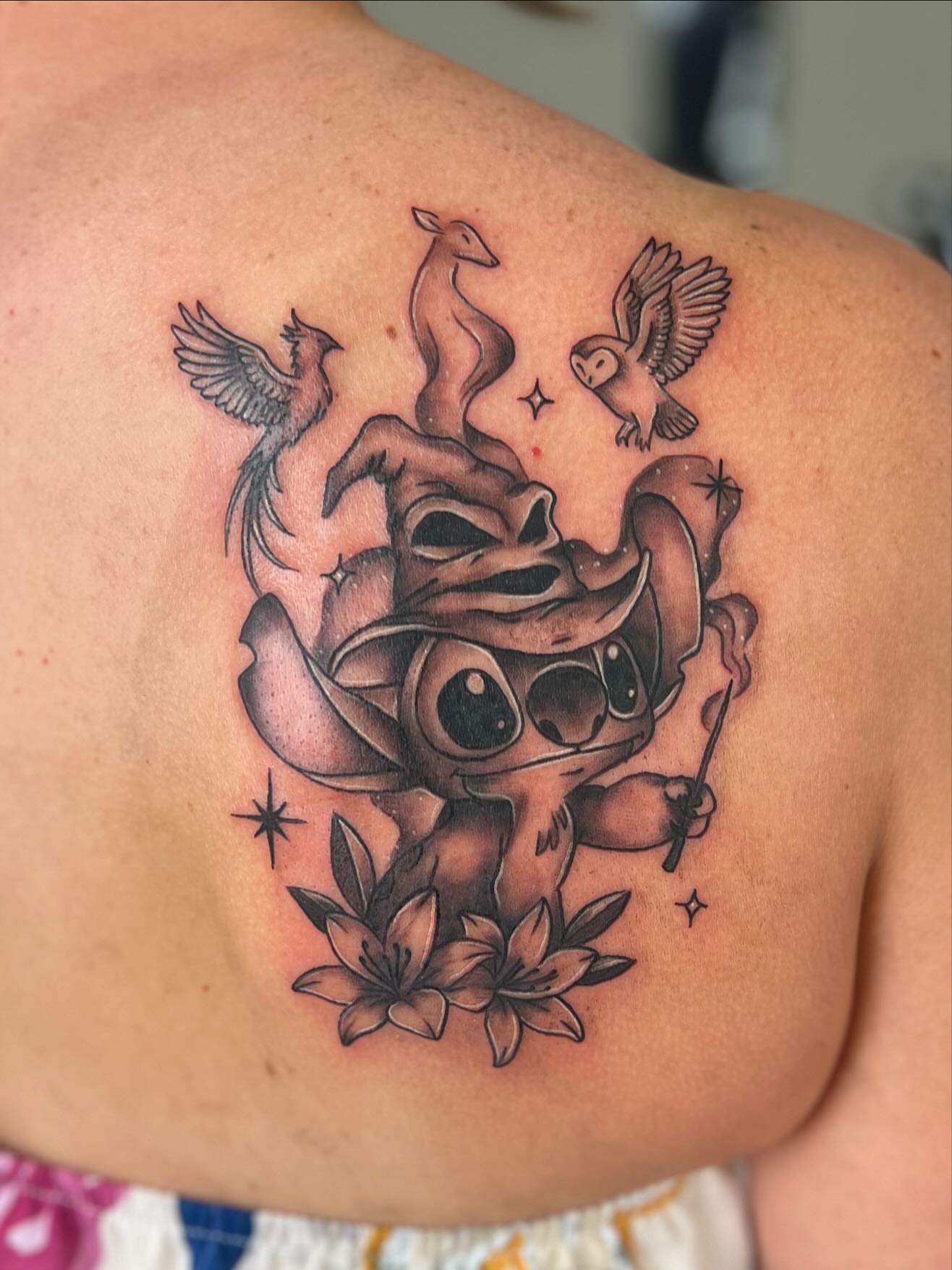 Stitch with birds and flowers new school tattoo on the shoulder by Jai Woods