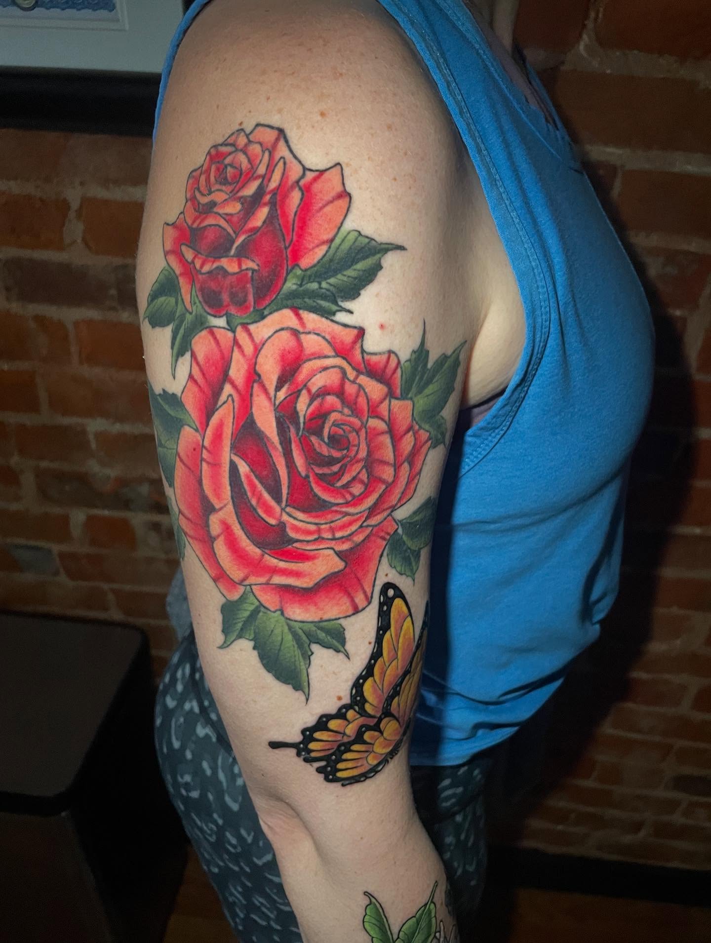 Roses and butterfly American traditional tattoo on the upper arm by Auzzy the Ink Pirate, Mansfield, Ohio