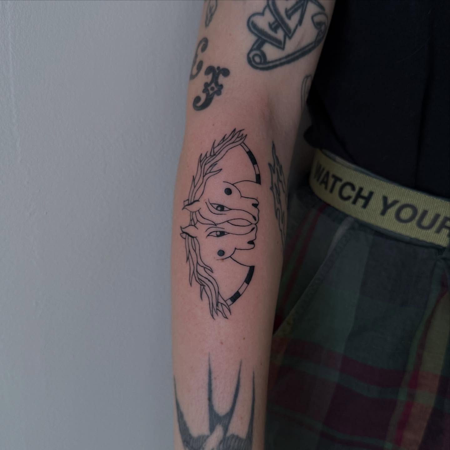 Abstract face minimalist tattoo on the forearm by house0fsleep 💤