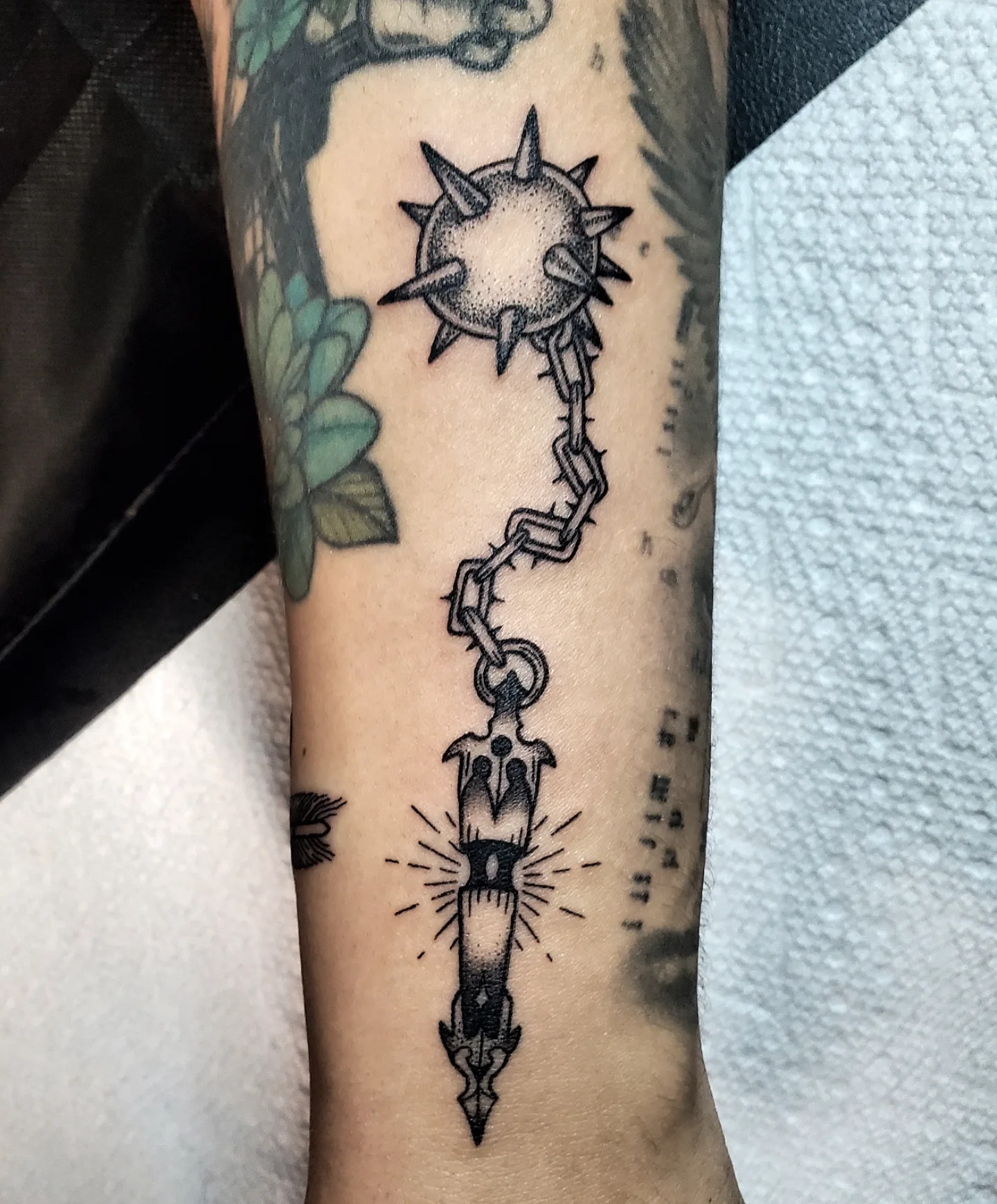 Chain and dagger dotwork tattoo on the forearm by Shailey Pasquale