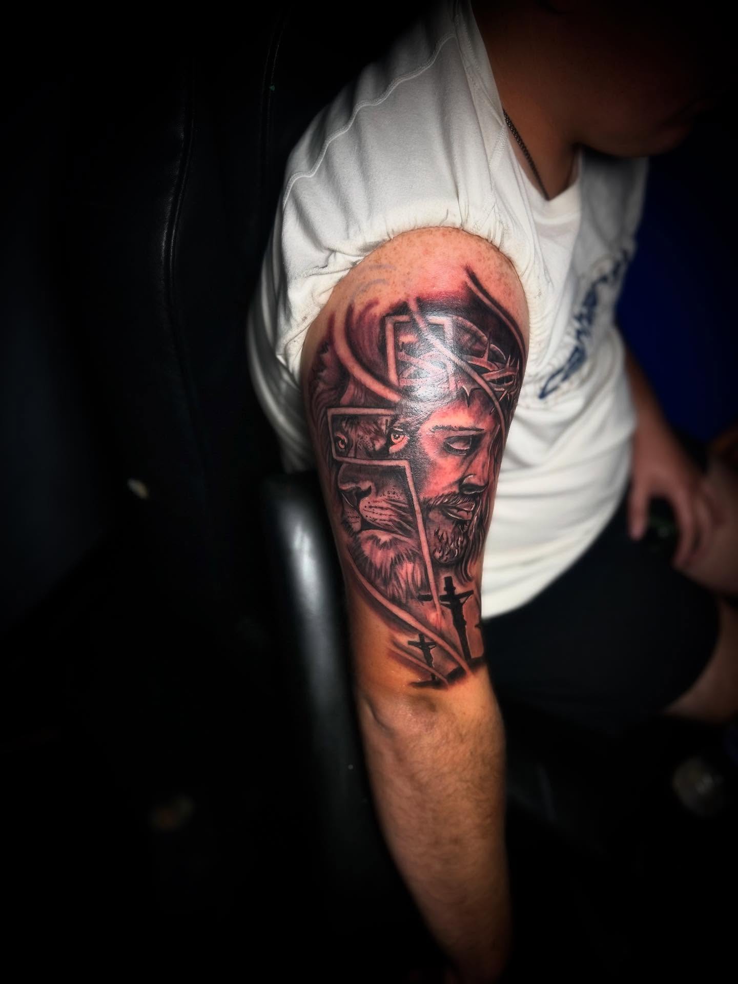 Man with beard and crown realism tattoo on the forearm by Rell Washington, Marlow Heights, Maryland