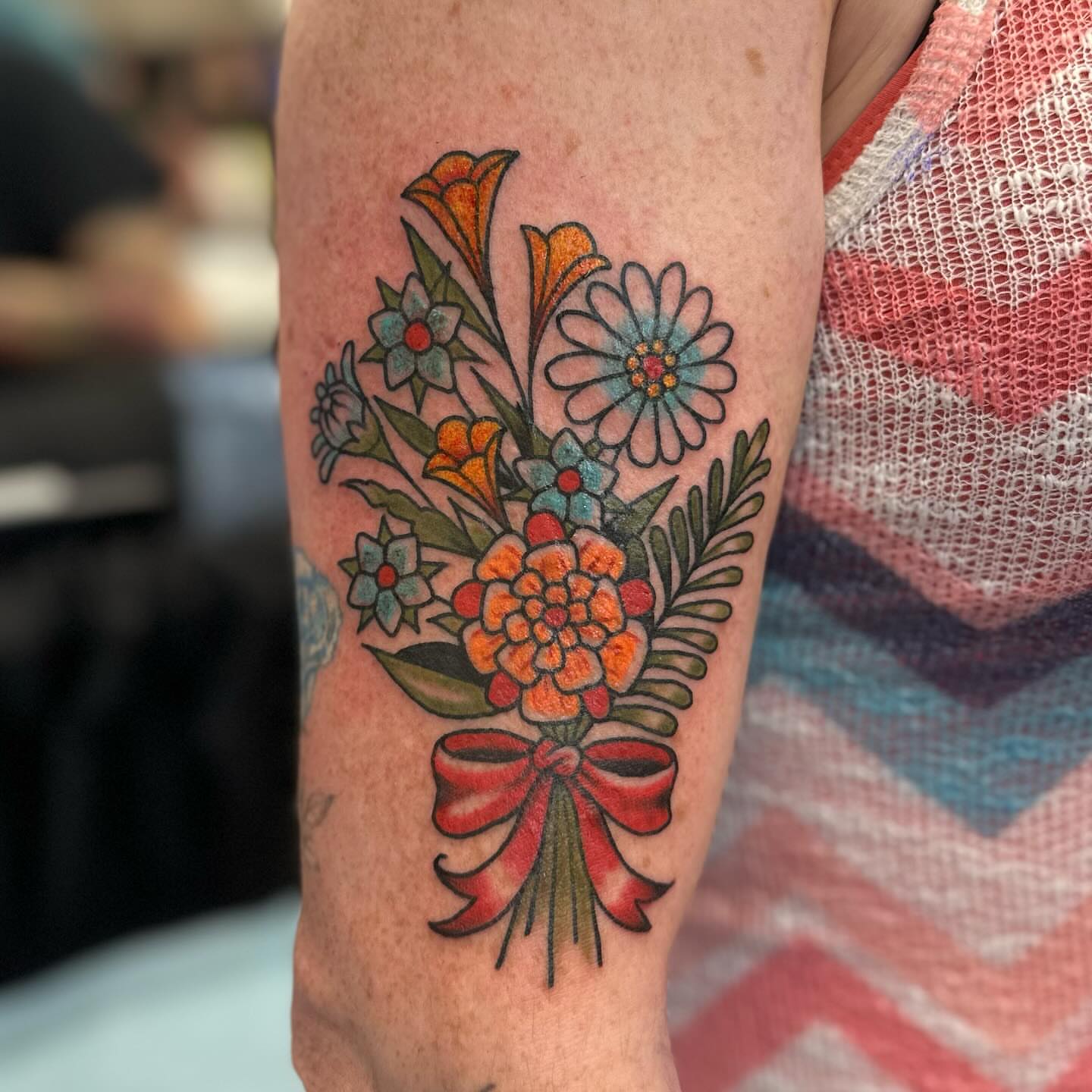 Flower bouquet American traditional tattoo on the forearm by Stacy Fevinger