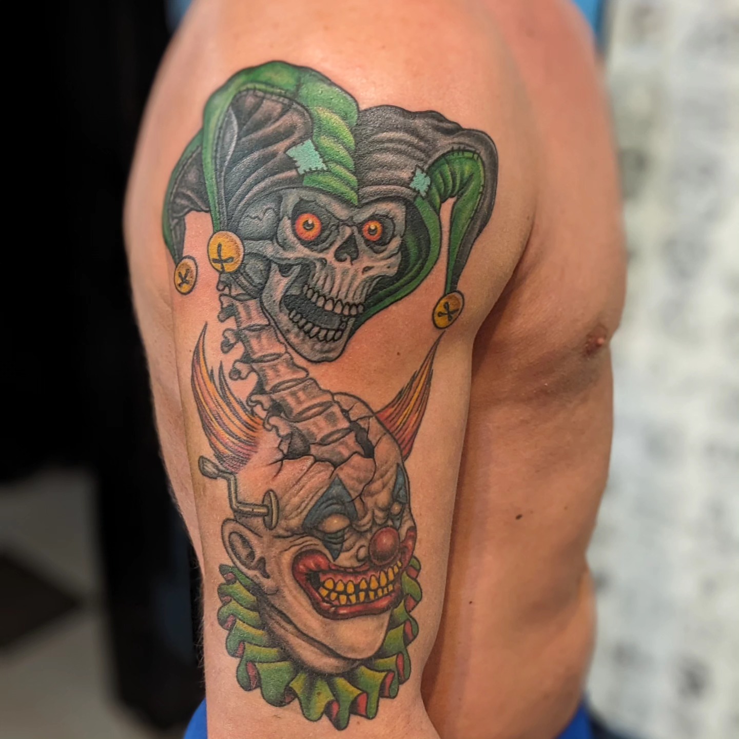 Joker skull American traditional tattoo on the shoulder by Matt Simmonds