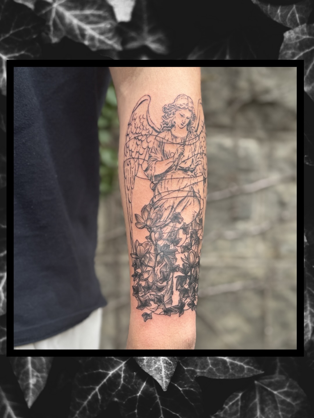 Angel with flowers black and grey tattoo on the forearm by Sydney
