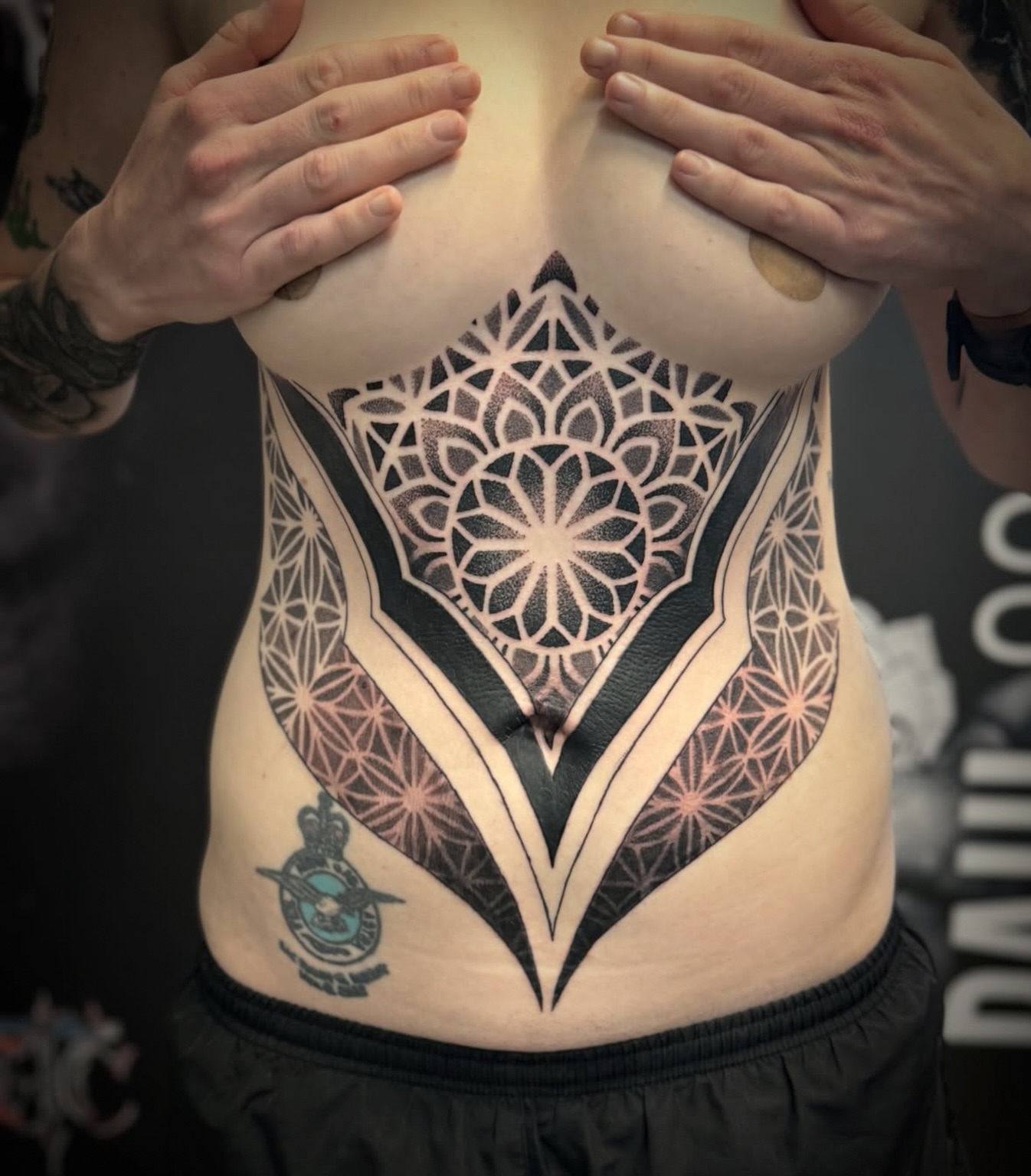 Geometric mandala geometric tattoo on the torso by Paul Schnell