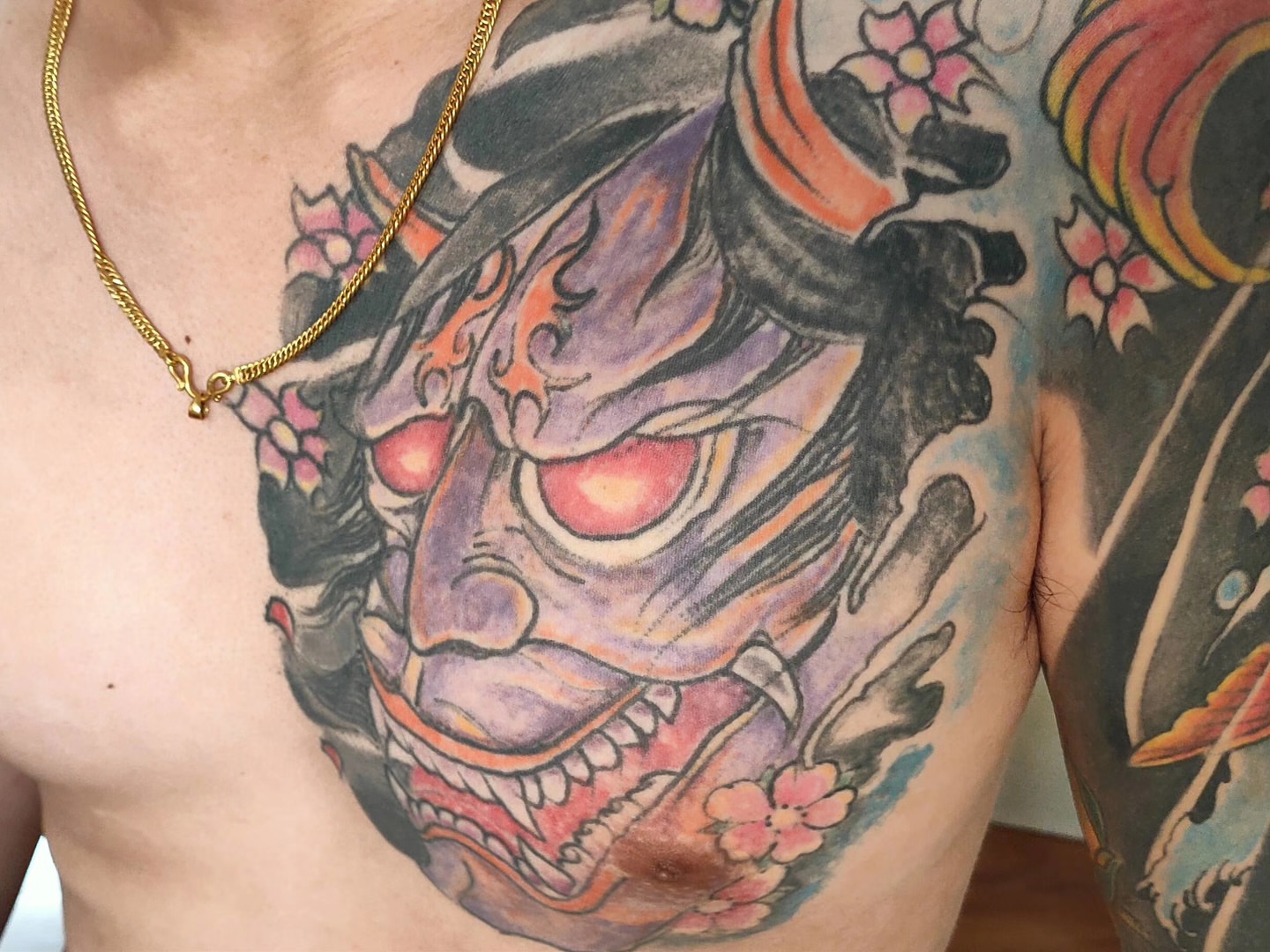 Demon mask japanese irezumi tattoo on the chest by Sydney Walk in Tattoo, Sydney, New South Wales