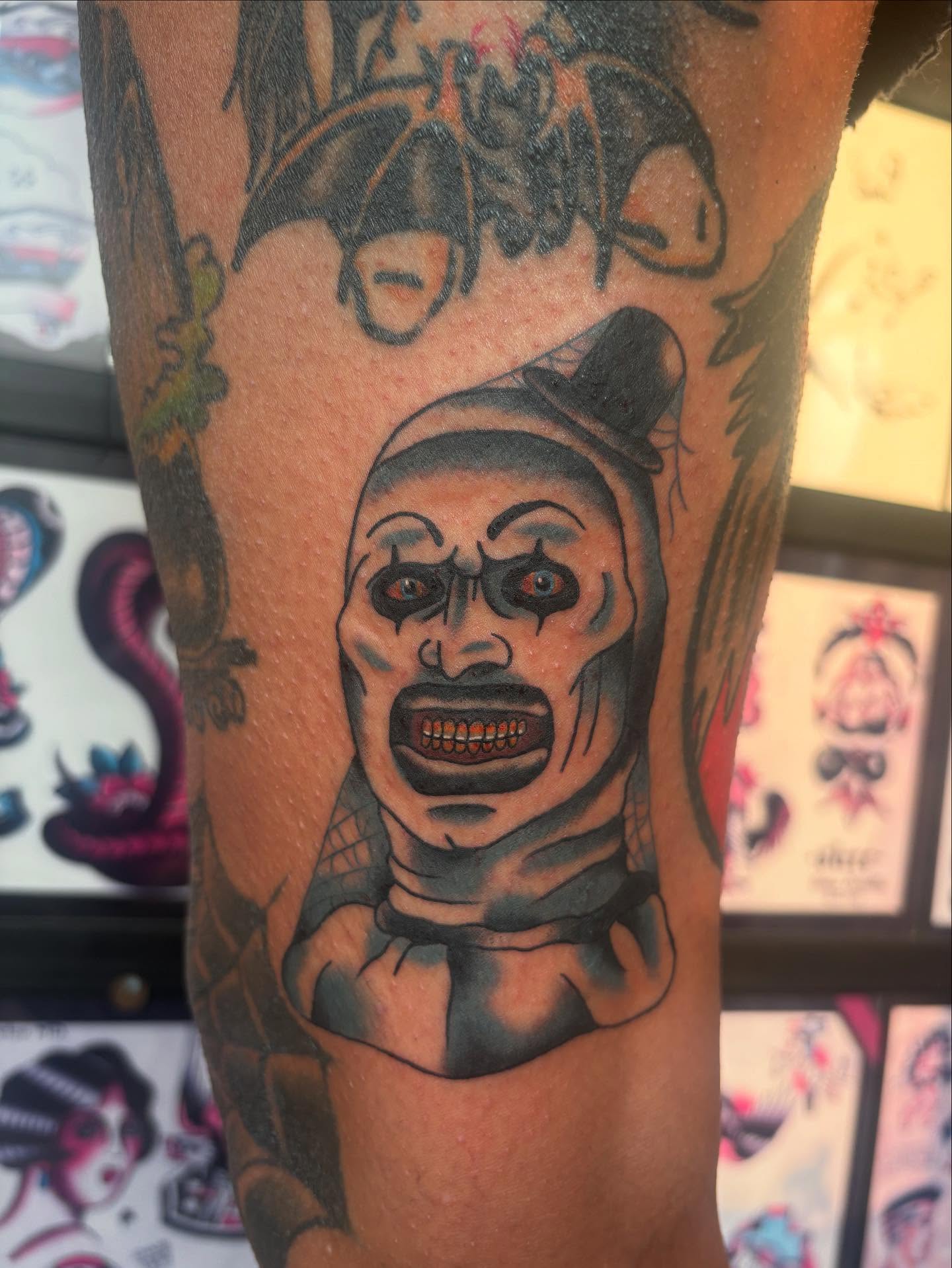 Clown black and grey tattoo on the forearm by Ben Whyte