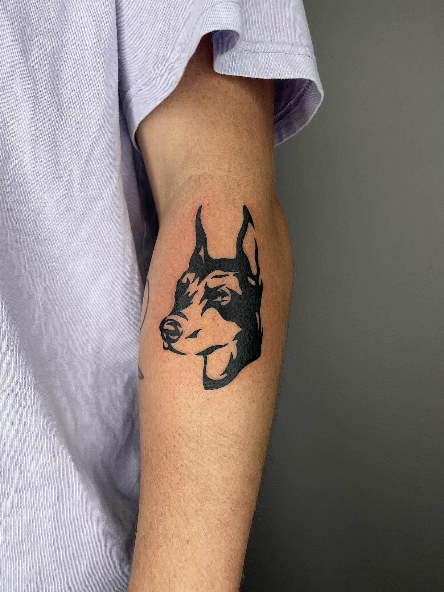 Dog head black and grey tattoo on the forearm by Thiên Hồ