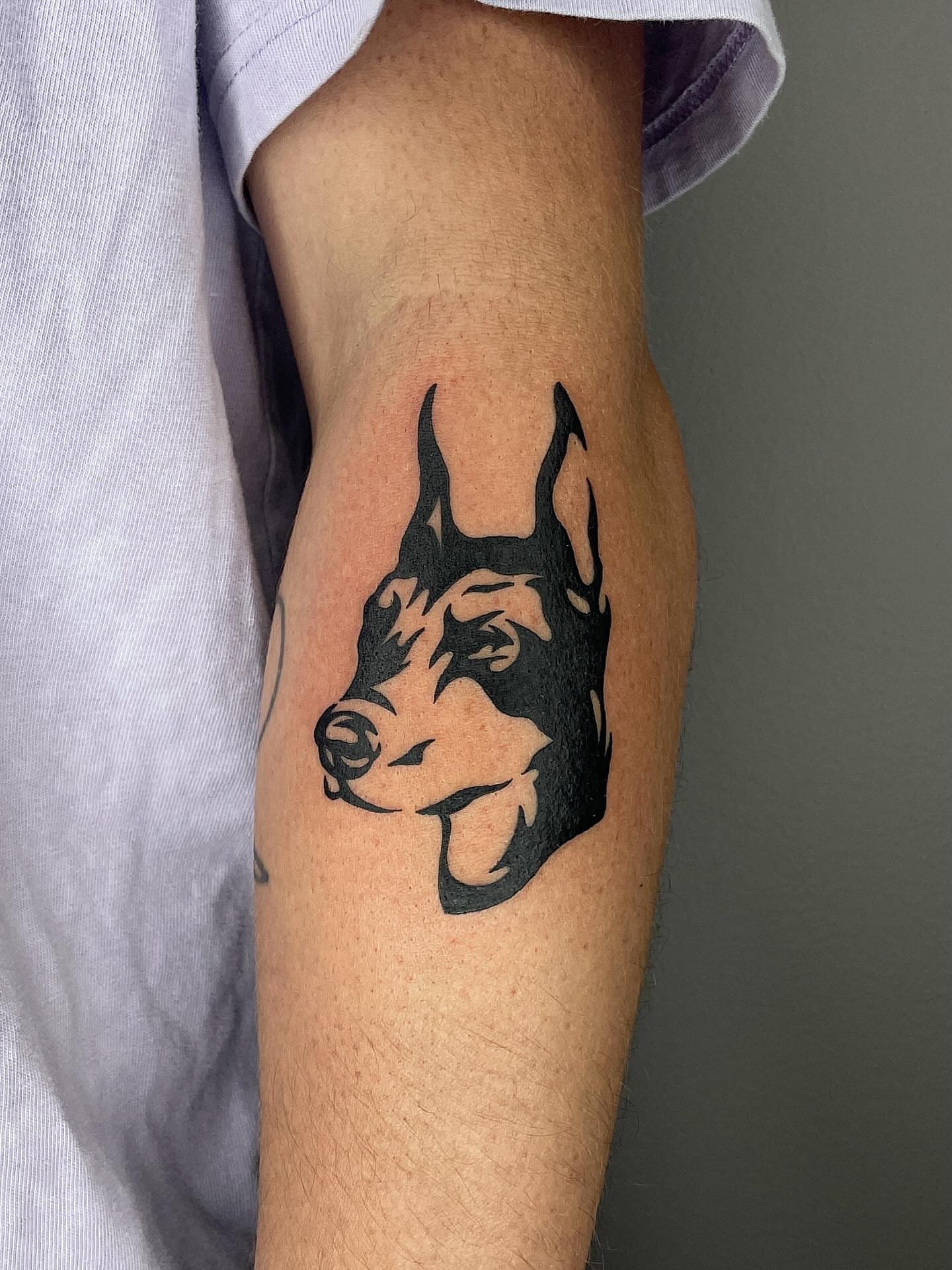 Dog head black and grey tattoo on the forearm by Thiên Hồ