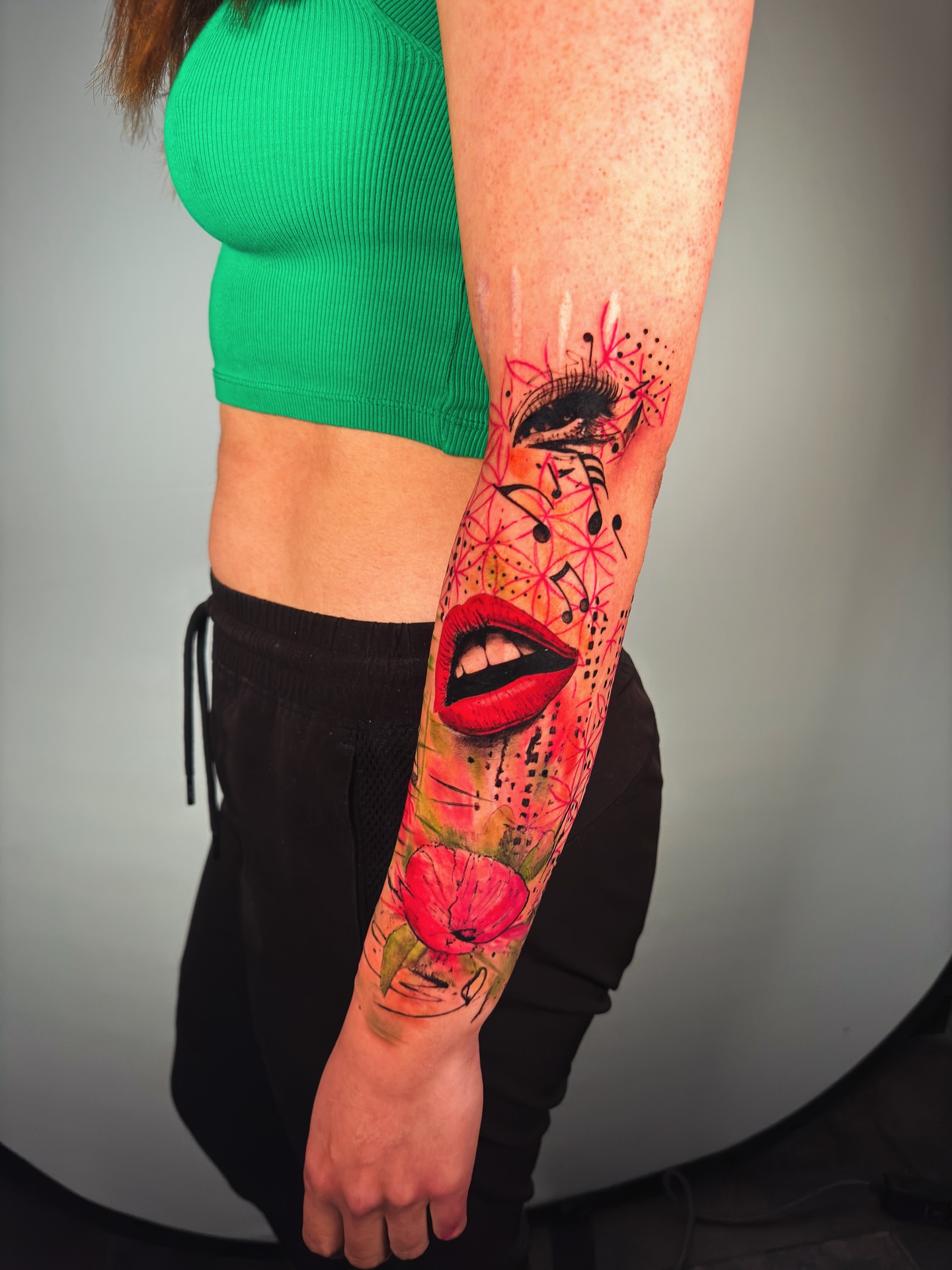 Lips and flowers dotwork tattoo on the forearm by Georgios Papadopoulos Tattoo Artist Los