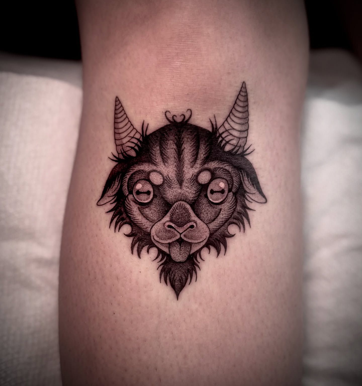 Goat head black and grey tattoo on the thigh by Melanie
