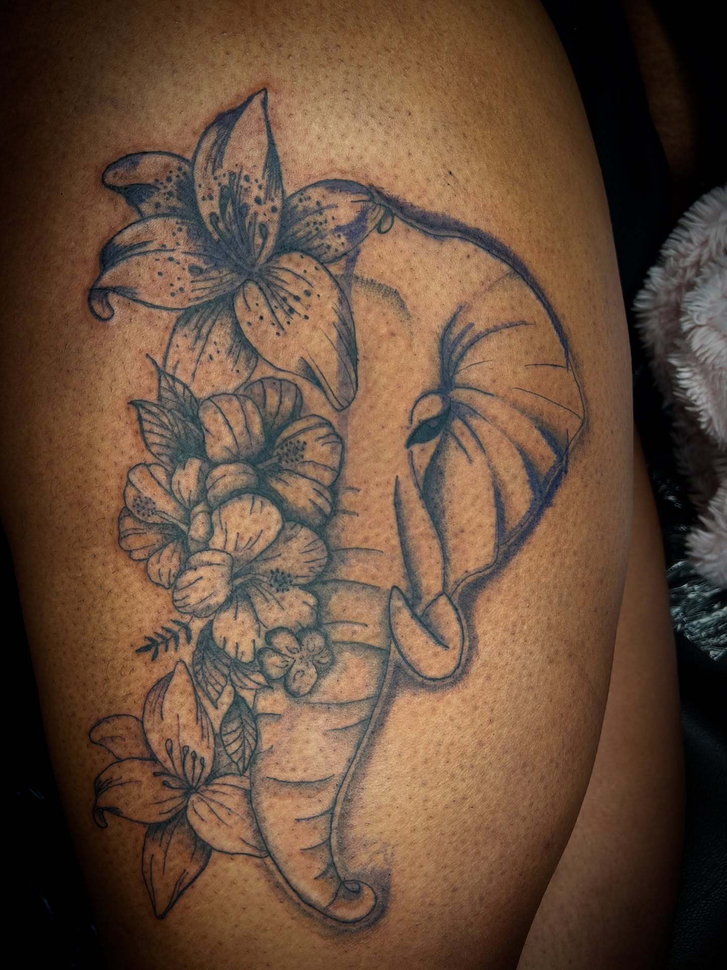 Lily and flowers black and grey tattoo on the thigh by Cleveland Tattoo Artist, Cleveland, Ohio