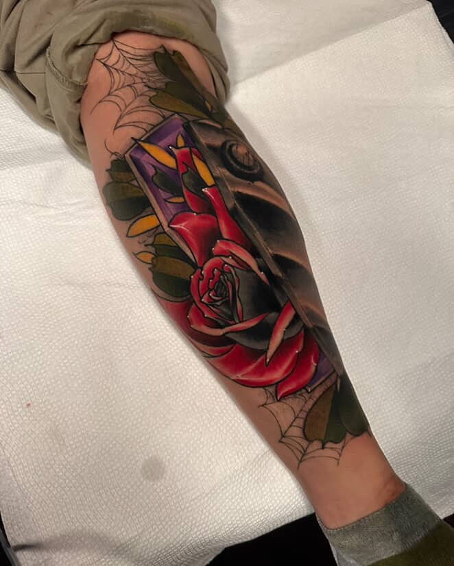 Rose American traditional tattoo on the forearm by E