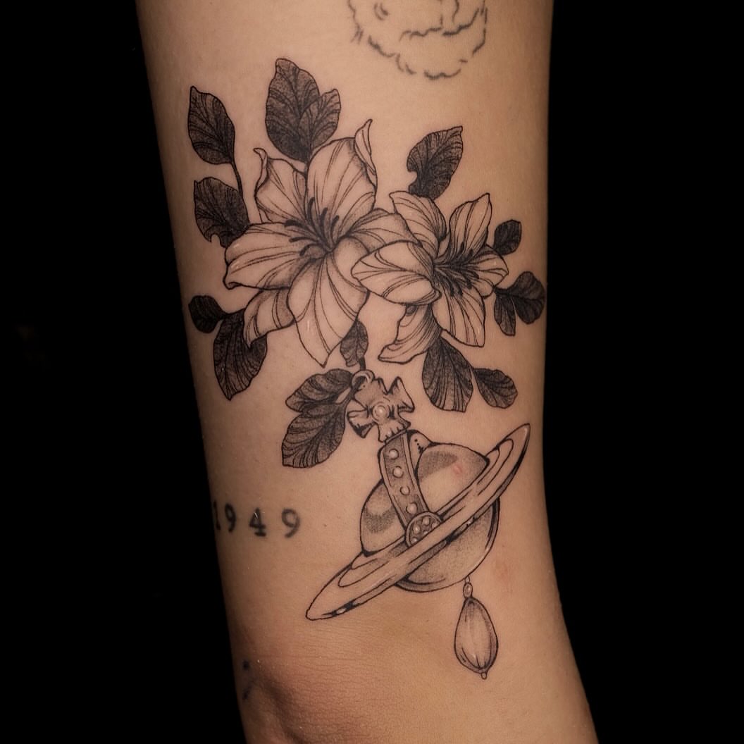 Flowers and planet realism tattoo on the forearm by misa (mi isabelle) β€οΈβπ₯π