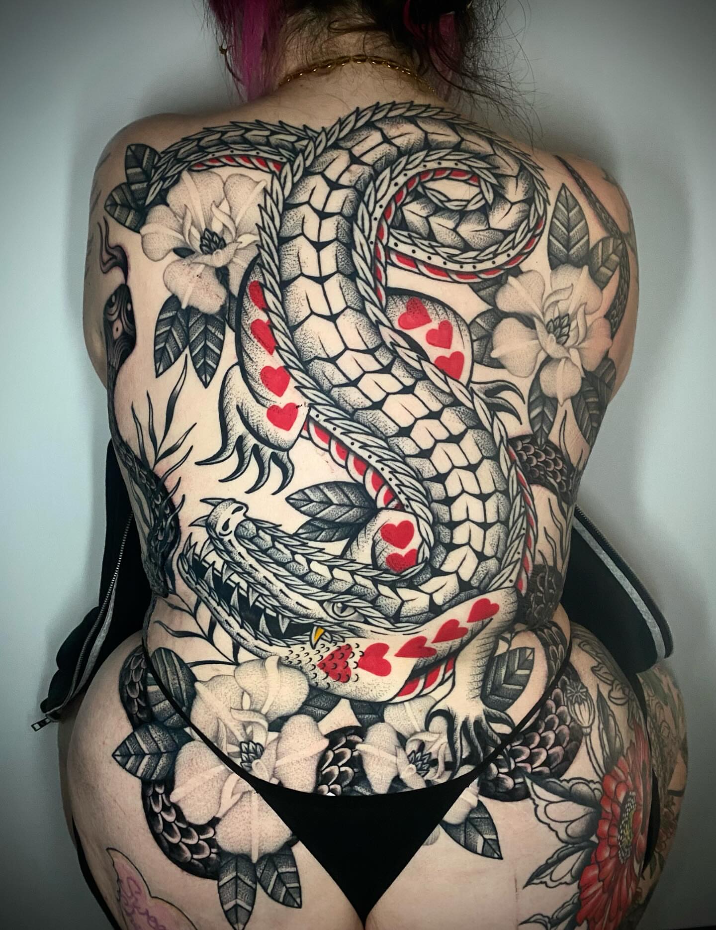 Snake and hearts American traditional tattoo on the back by Jason Ryan