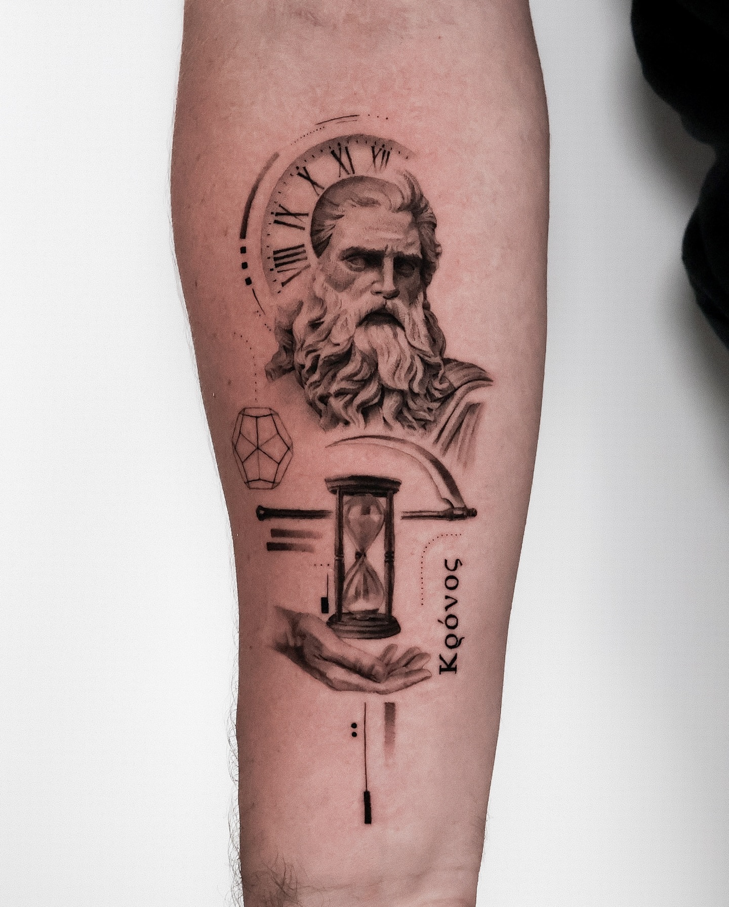 Ancient figure with clock realism tattoo on the forearm by Riley K Turner