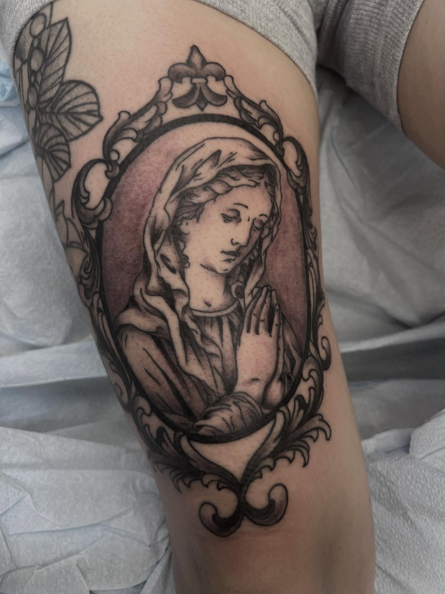 Religious figure realism tattoo on the thigh by Cody Marl