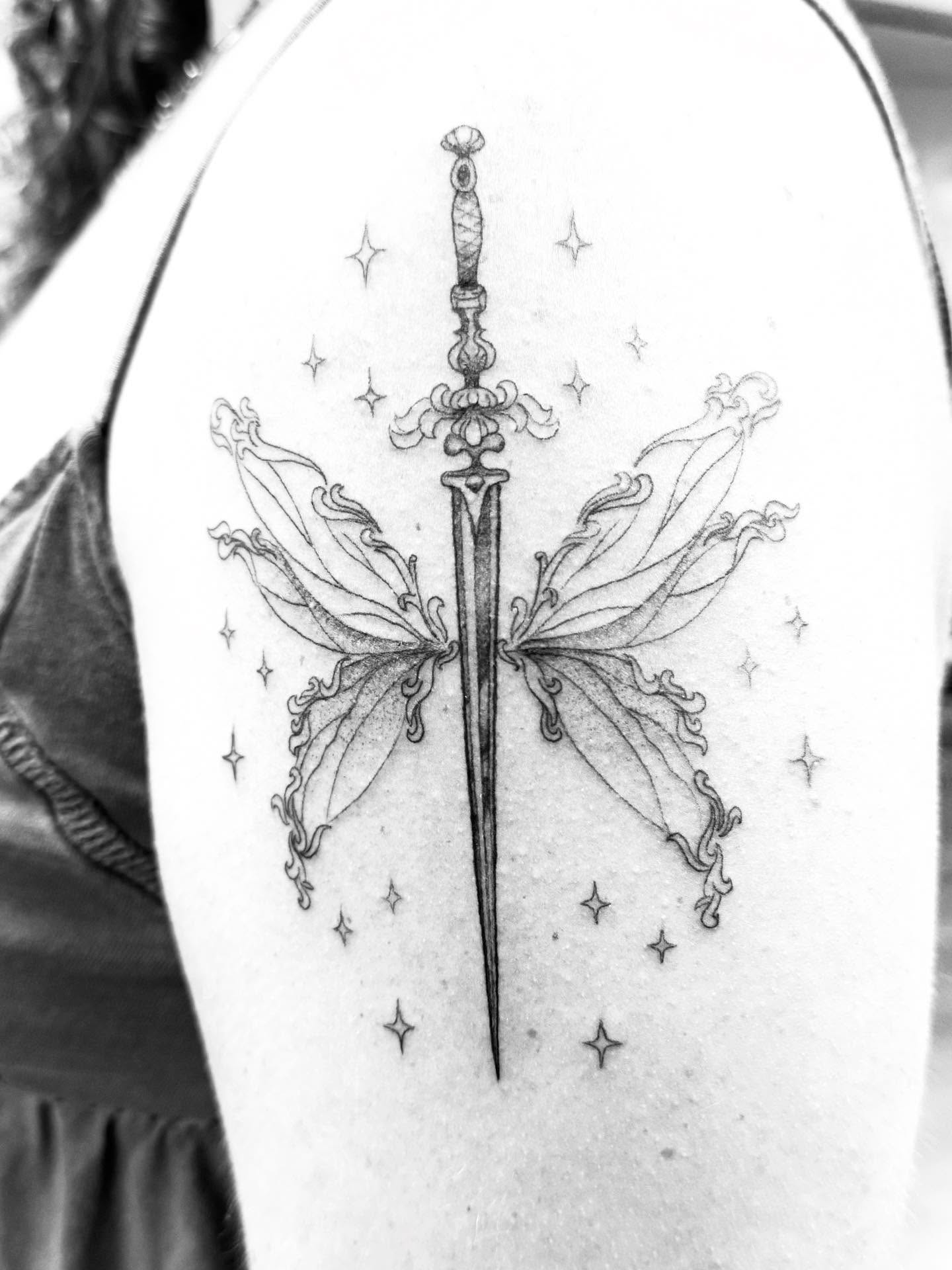 Sword and butterfly ornamental tattoo on the shoulder by Aaron Hassler, Nashville, Tennessee