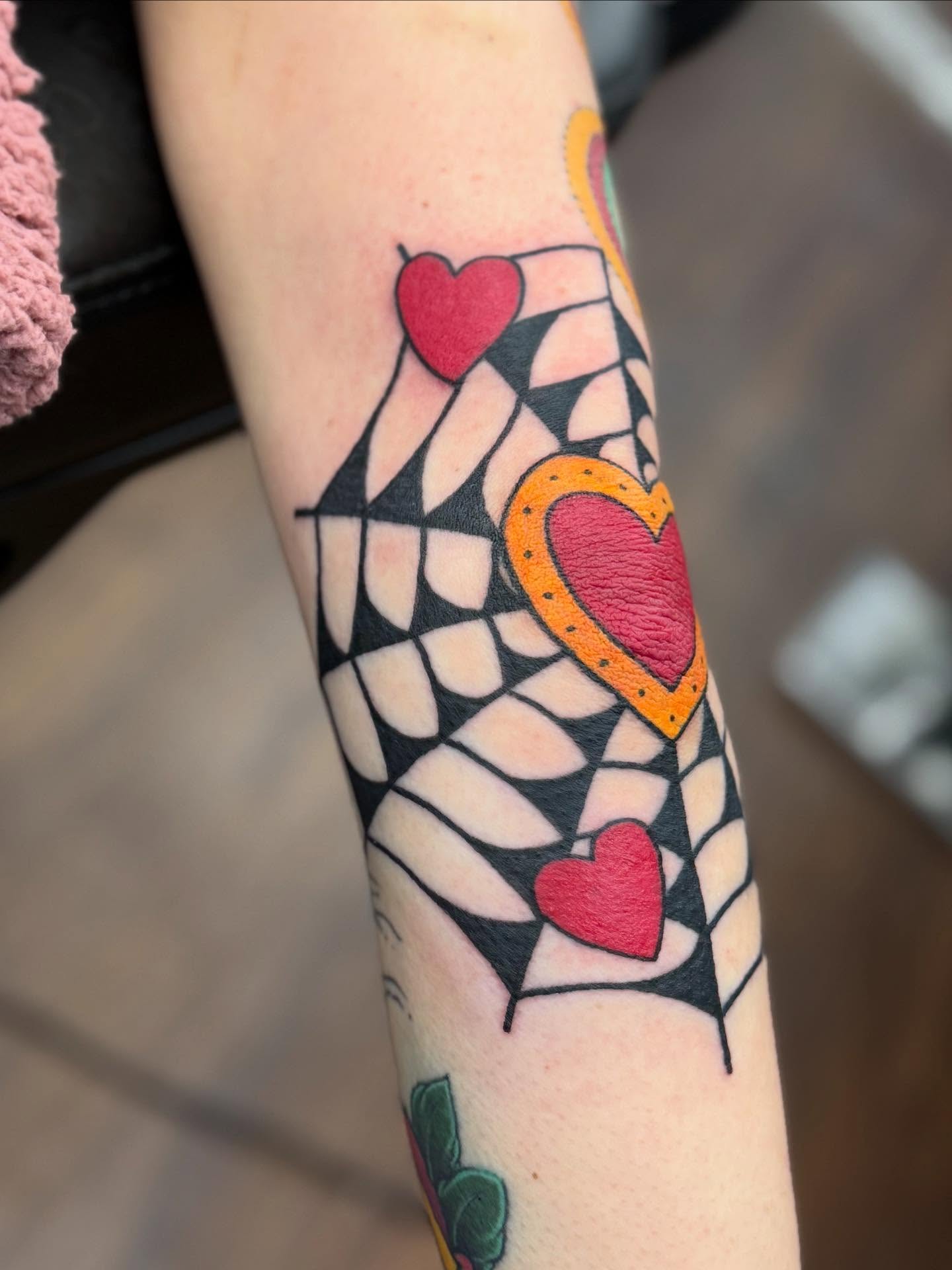 Geometric hearts American traditional tattoo on the forearm by Aaron Hassler, Nashville, Tennessee