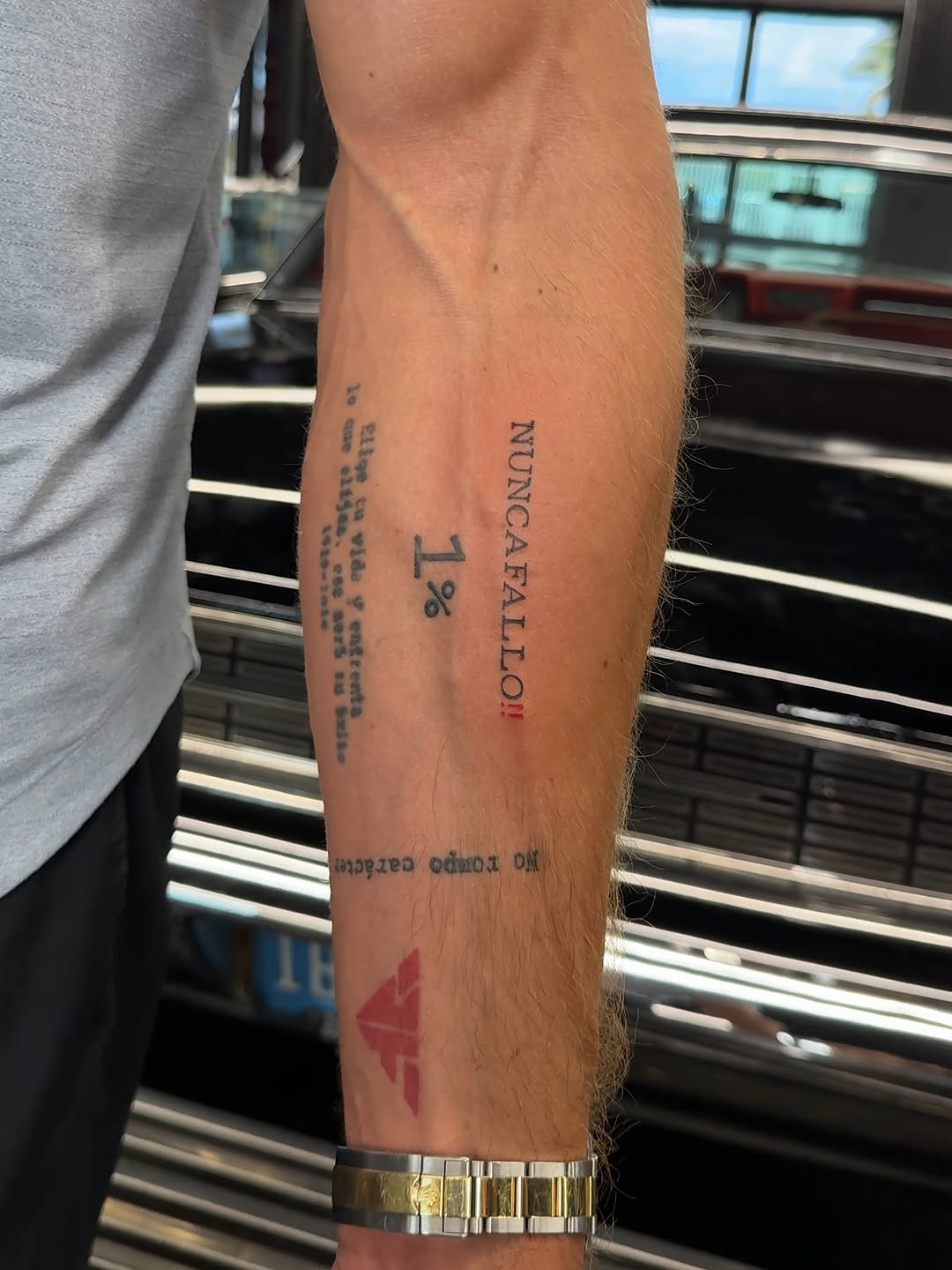 Text and symbol lettering tattoo on the forearm by @blackastaratattoo