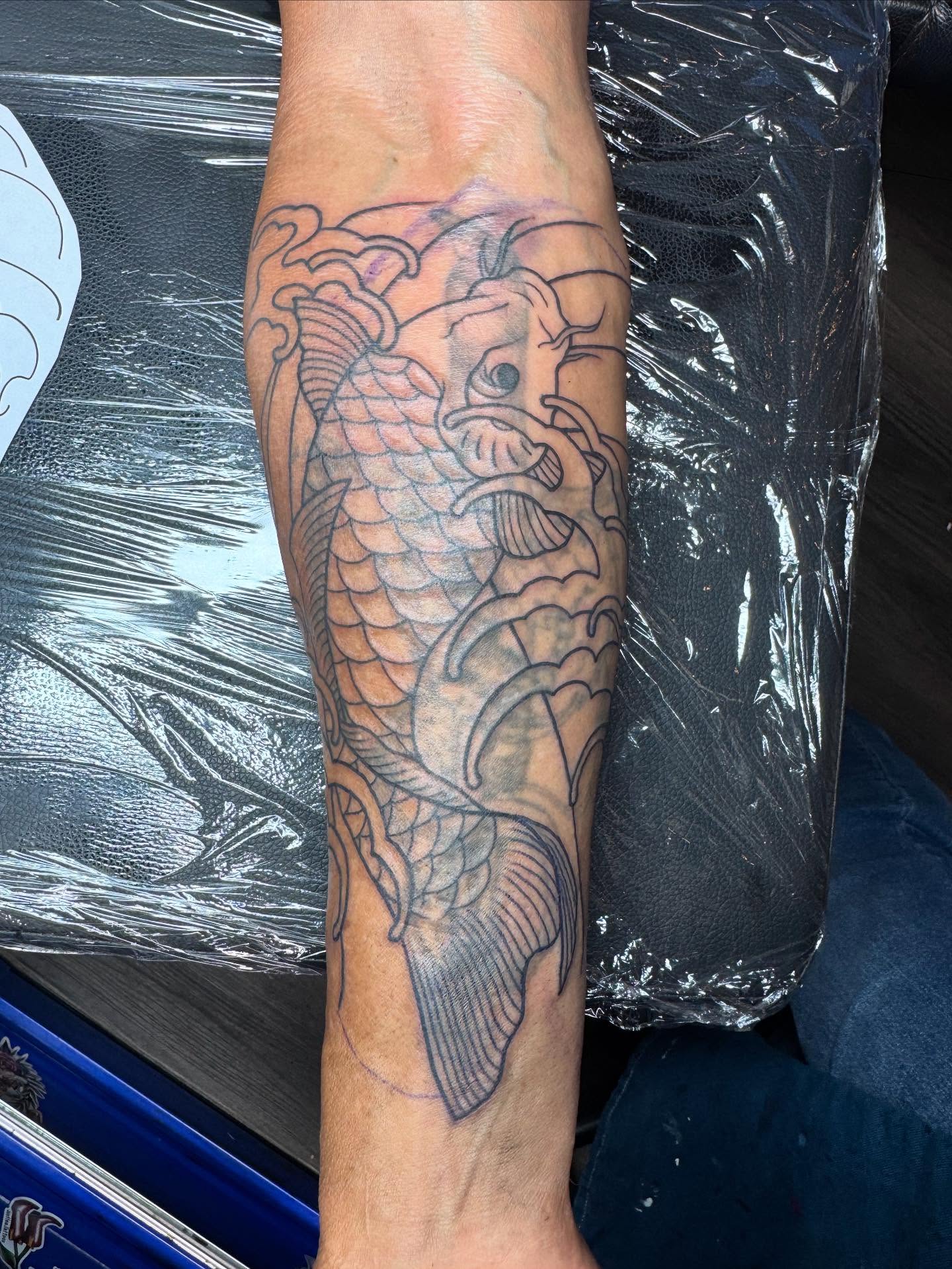 Koi fish black and grey tattoo on the forearm by Justina🪐