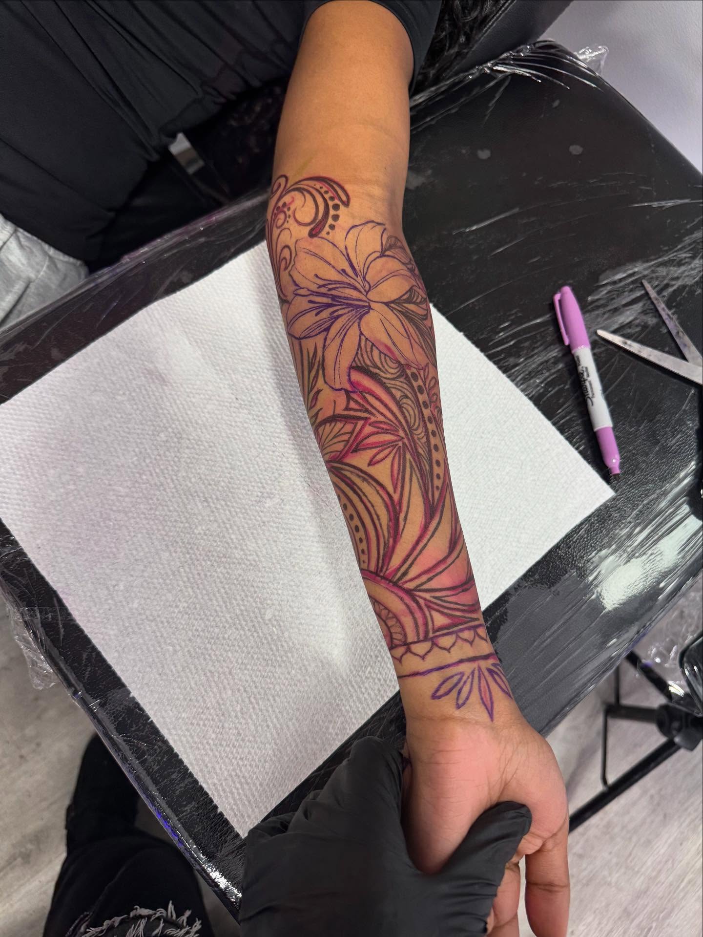 Lily and floral pattern new school tattoo on the forearm by Tattedbytrinn