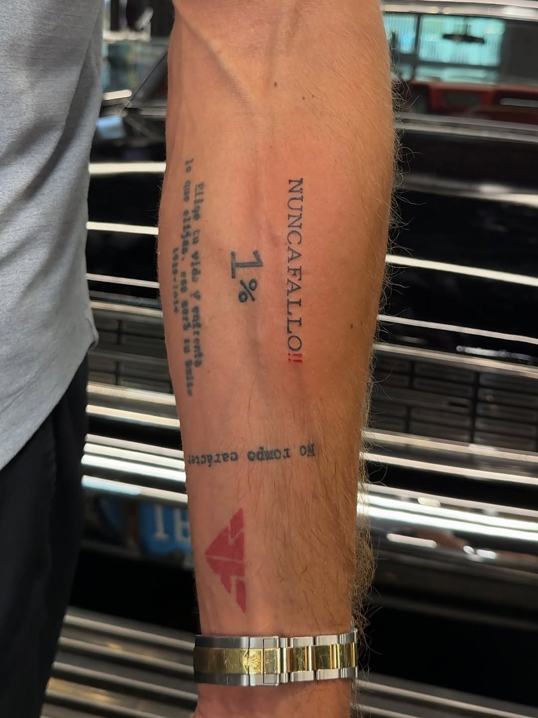 Text and symbol lettering tattoo on the forearm by @blackastaratattoo