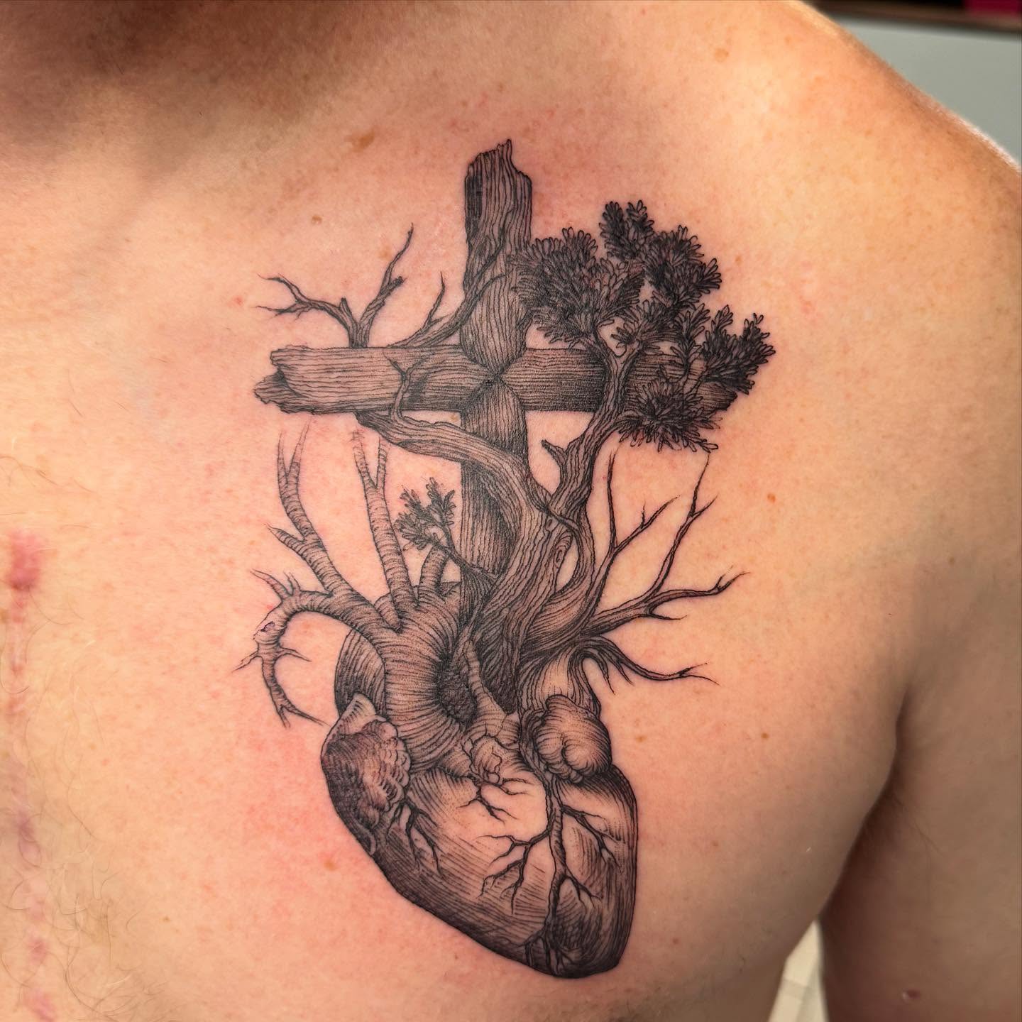 Heart and tree realism tattoo on the chest by Joey Flaherty