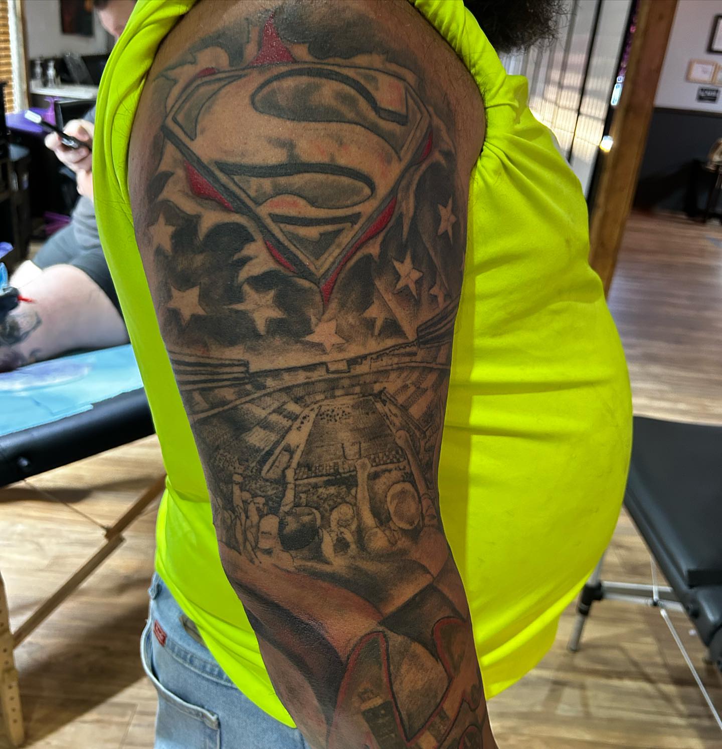 Superman American traditional tattoo on the upper arm by Cody Lambert