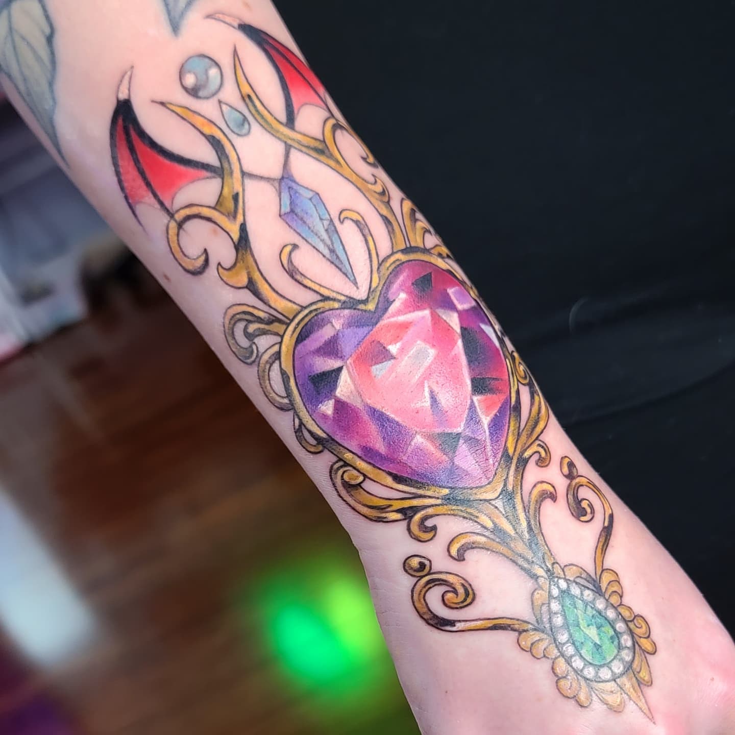 Gemstone and ornate frame ornamental tattoo on the forearm by Kerry Rose