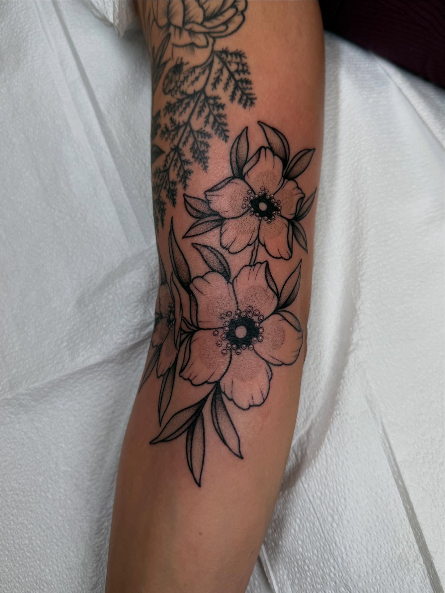 Flowers black and grey tattoo on the forearm by Erin Shea