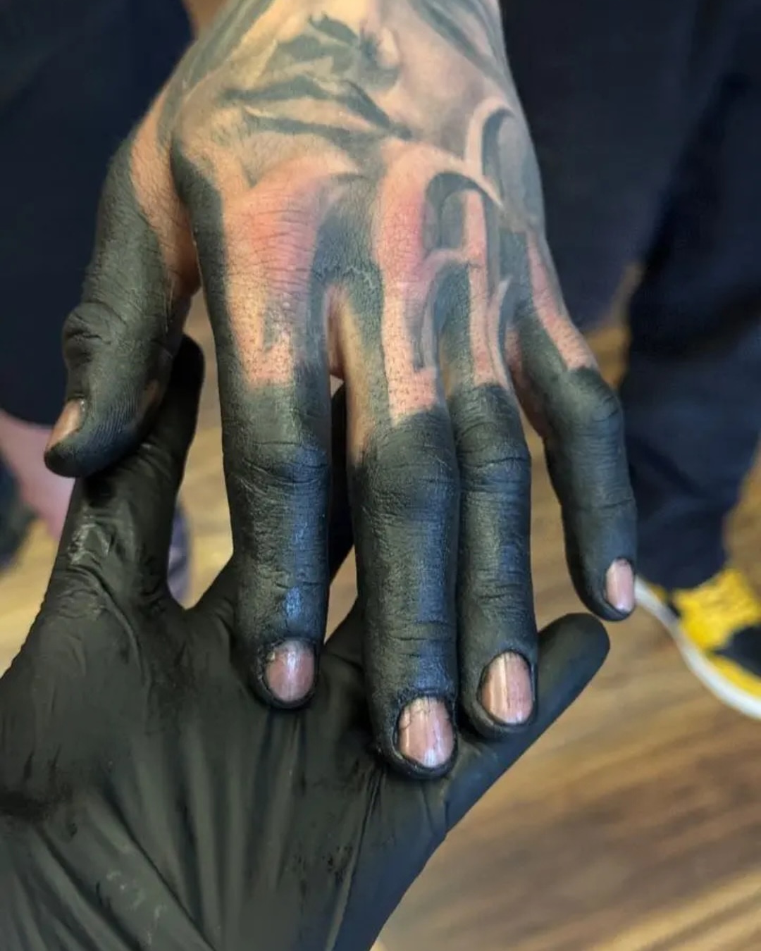 Hand black and grey tattoo on the hand by Denver Blackout Tattoo Specialist - Anthony