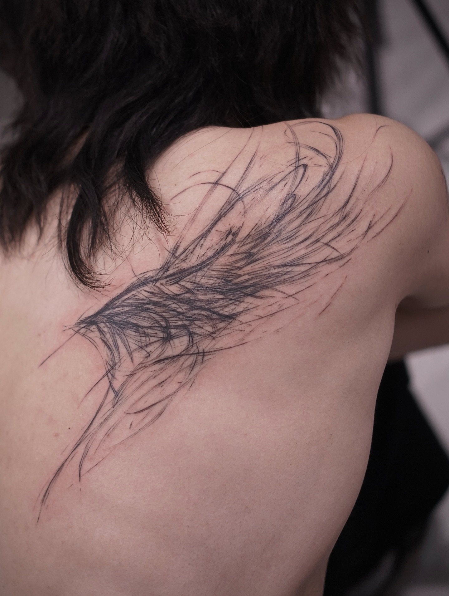 Feather black and grey tattoo on the shoulder by Young one 영원