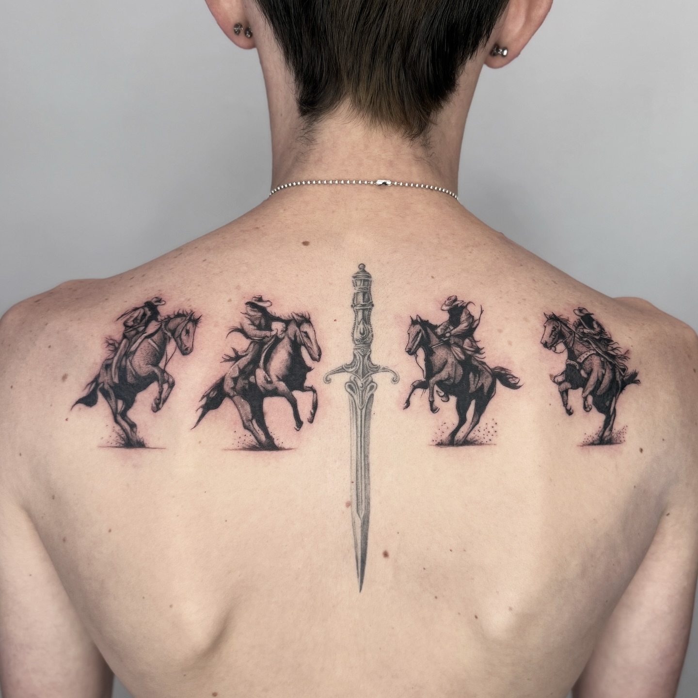 Horses and riders realism tattoo on the back by Miro Ink Tattoo