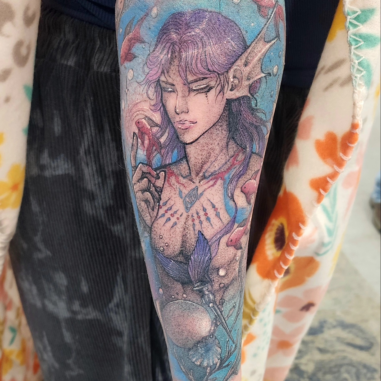 Elf with fish dotwork tattoo on the forearm by Diane Maya