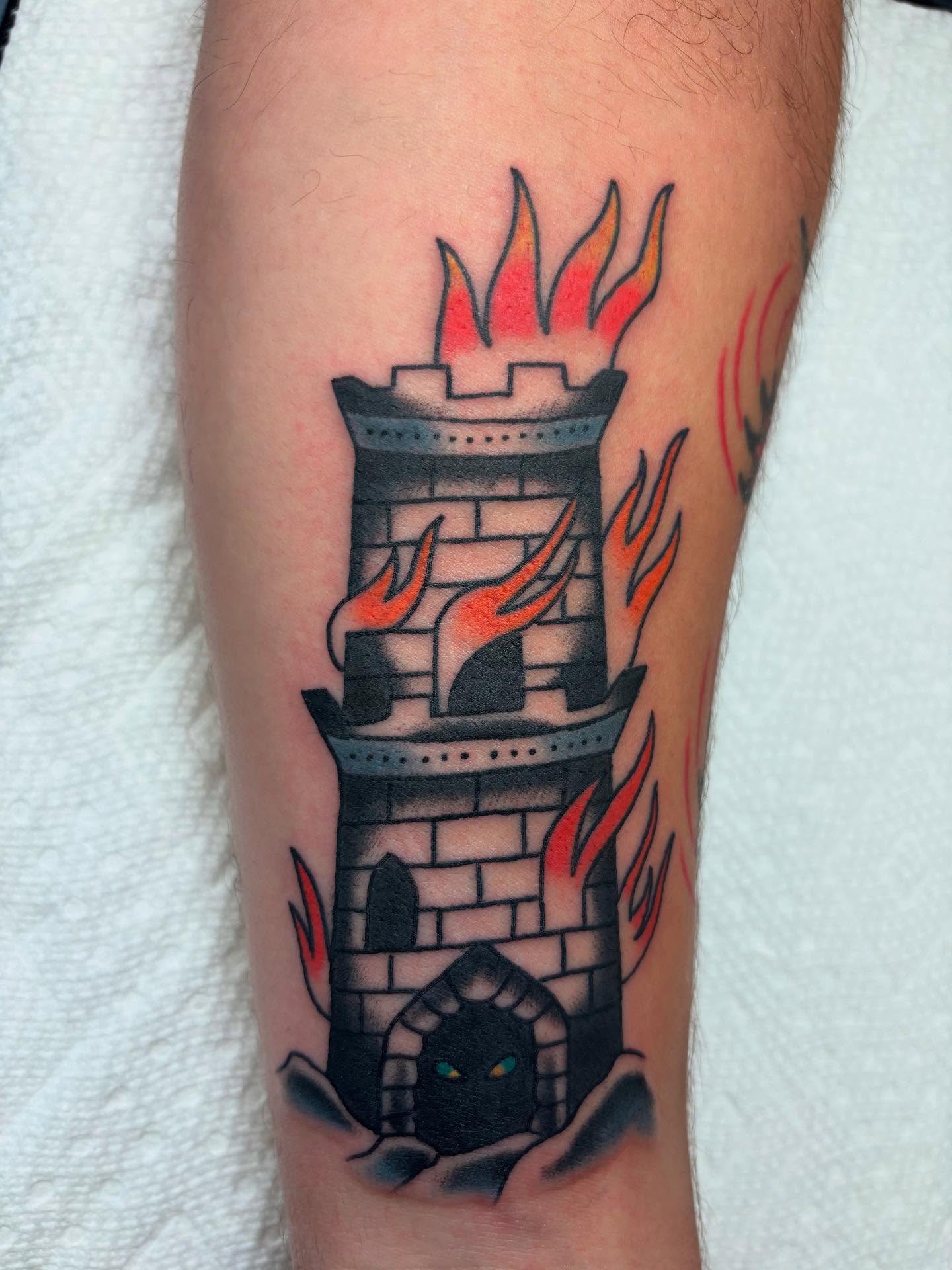 Castle with flames American traditional tattoo on the forearm by Ben Whyte
