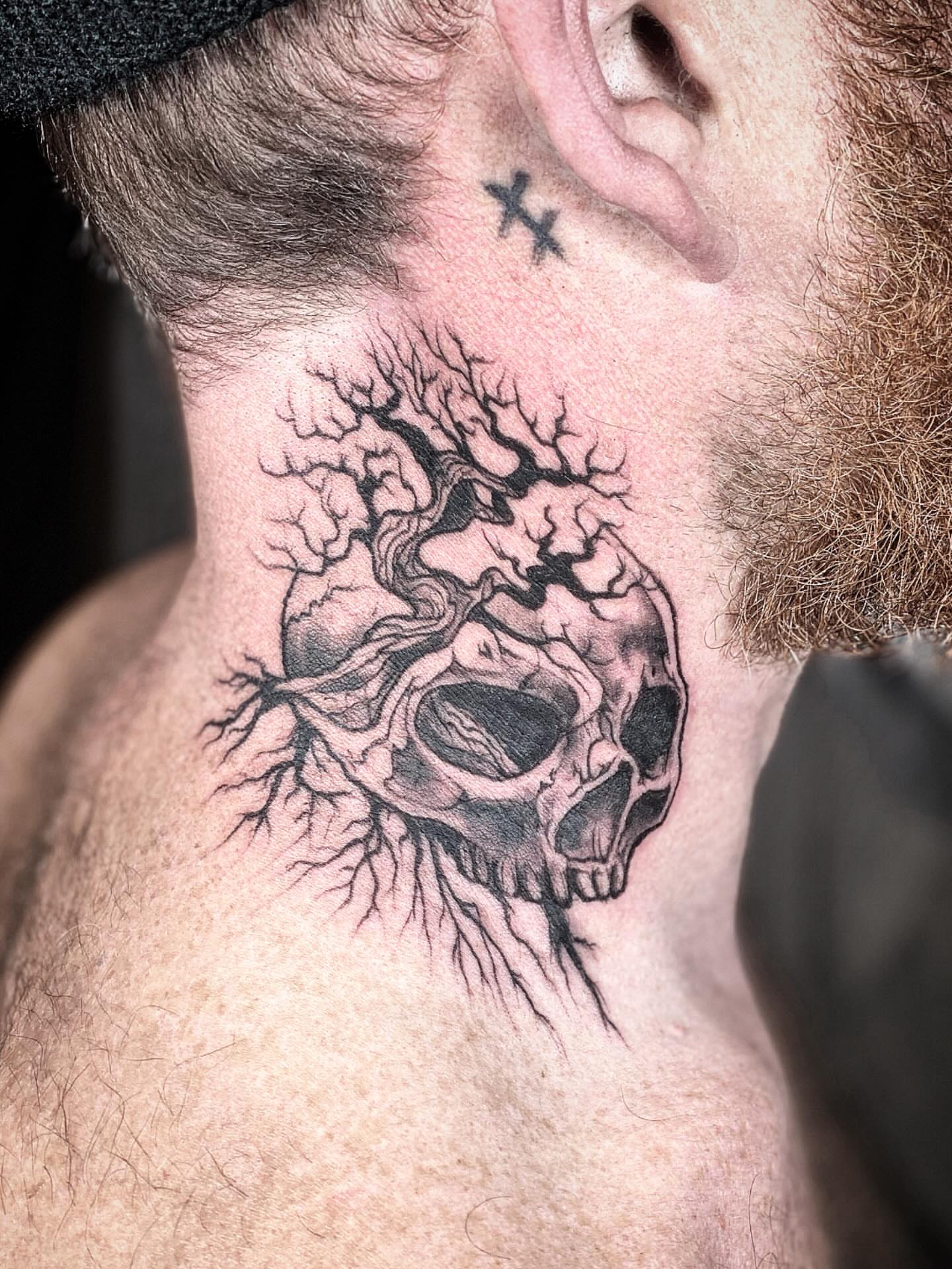Skull with tree roots realism tattoo on the neck by Chris Klee