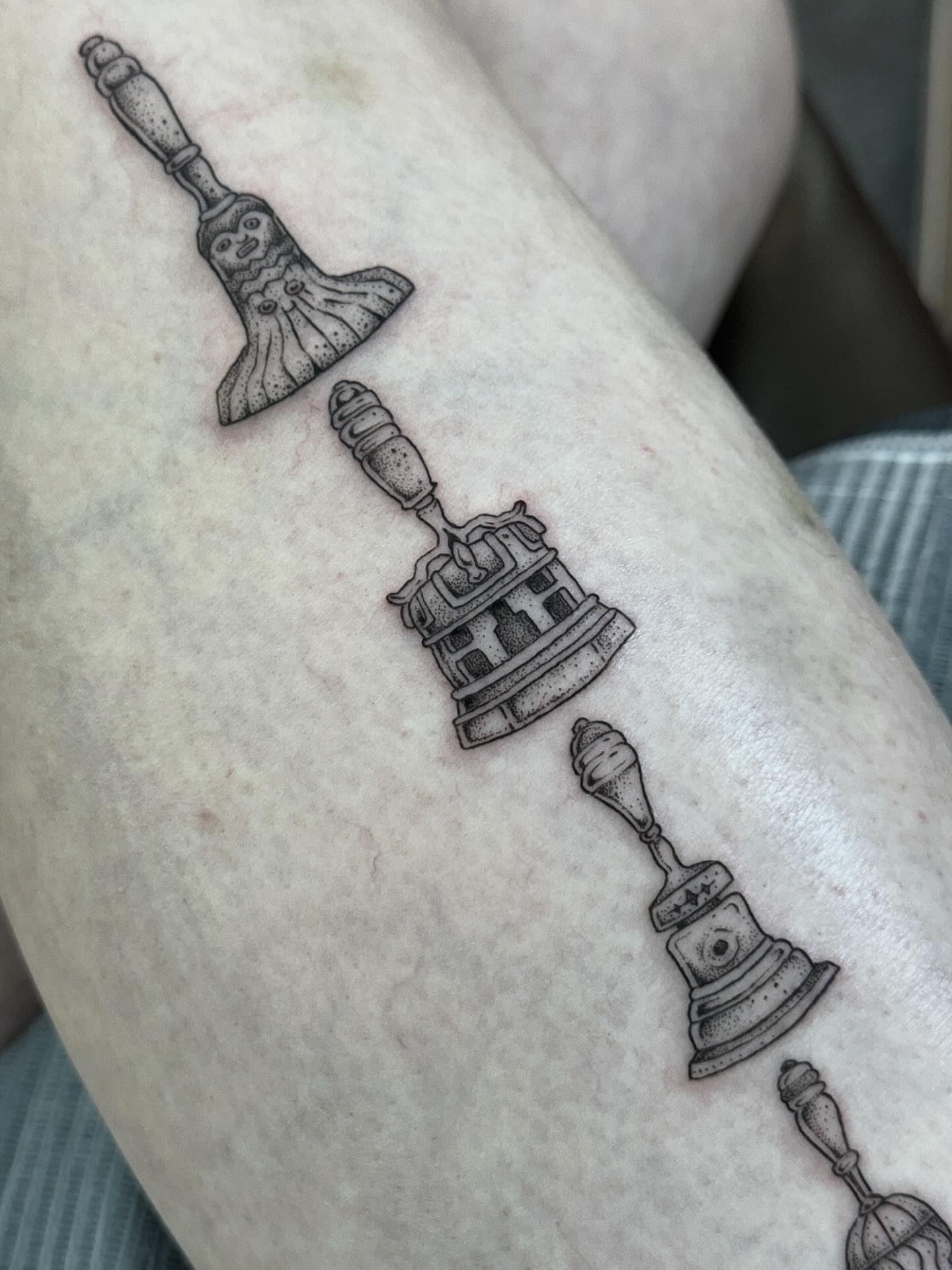 Prayer wheels black and grey tattoo on the forearm by Writhe Grey