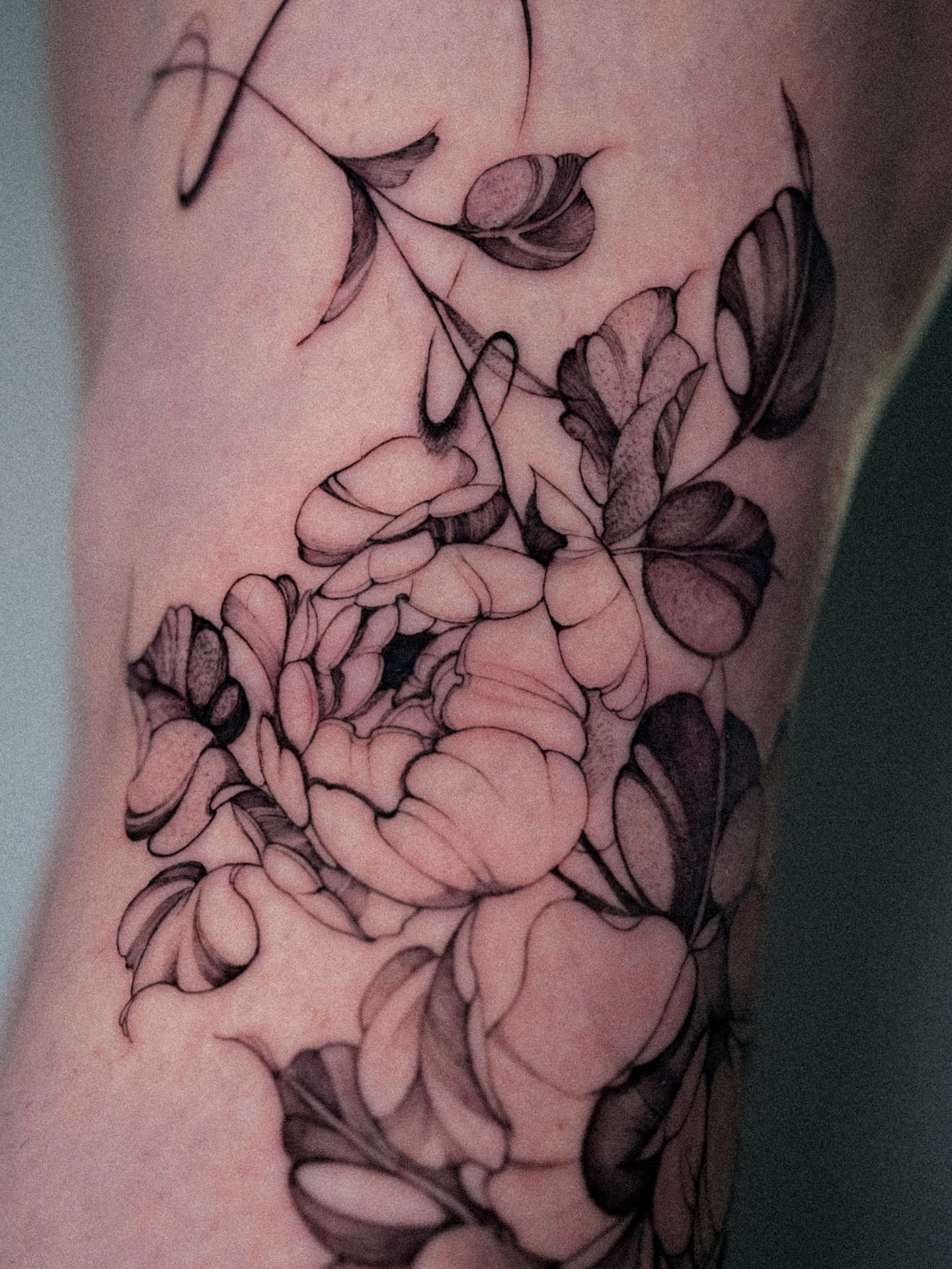 Flowers black and grey tattoo on the forearm by @katuvetattoo