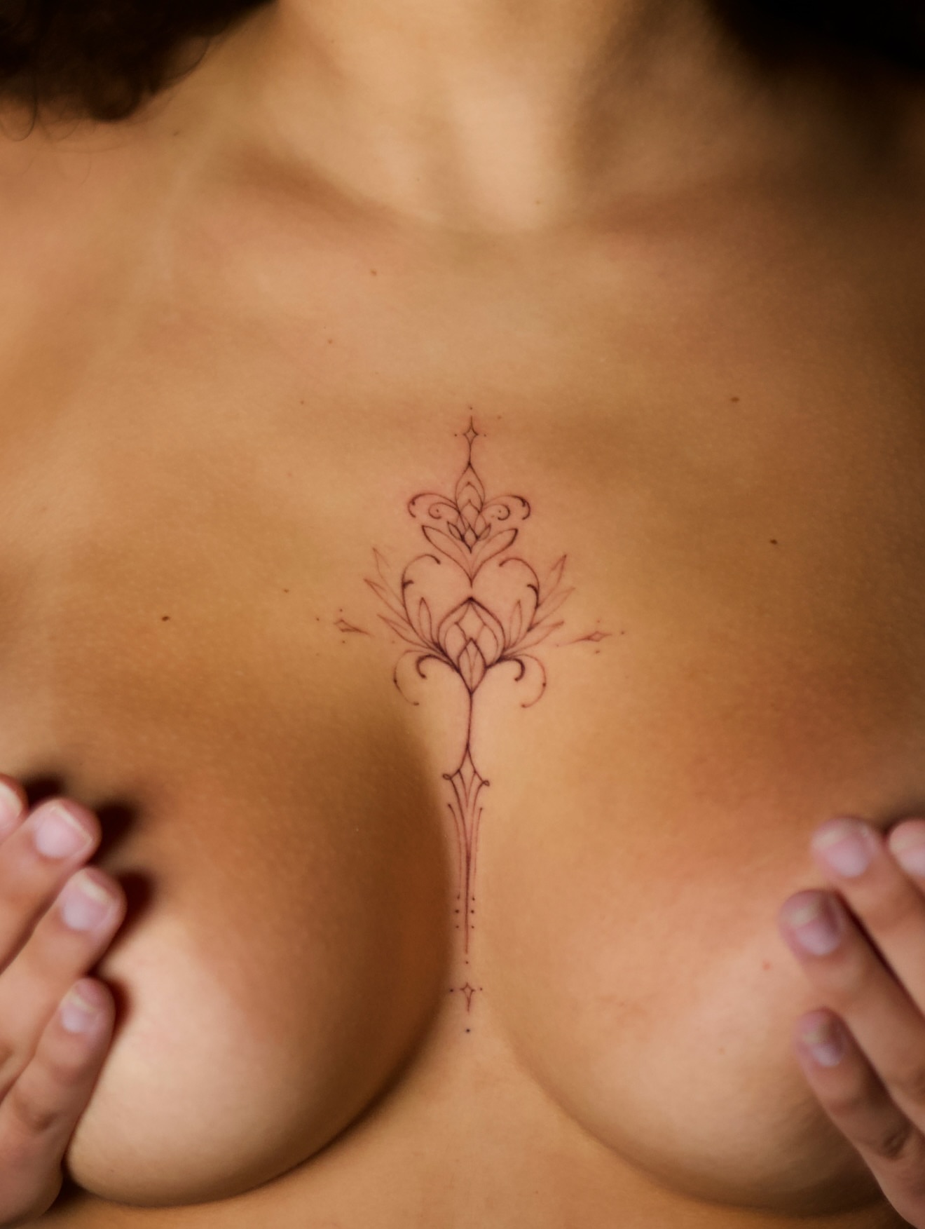 Lotus ornamental tattoo on the chest by @blackastaratattoo
