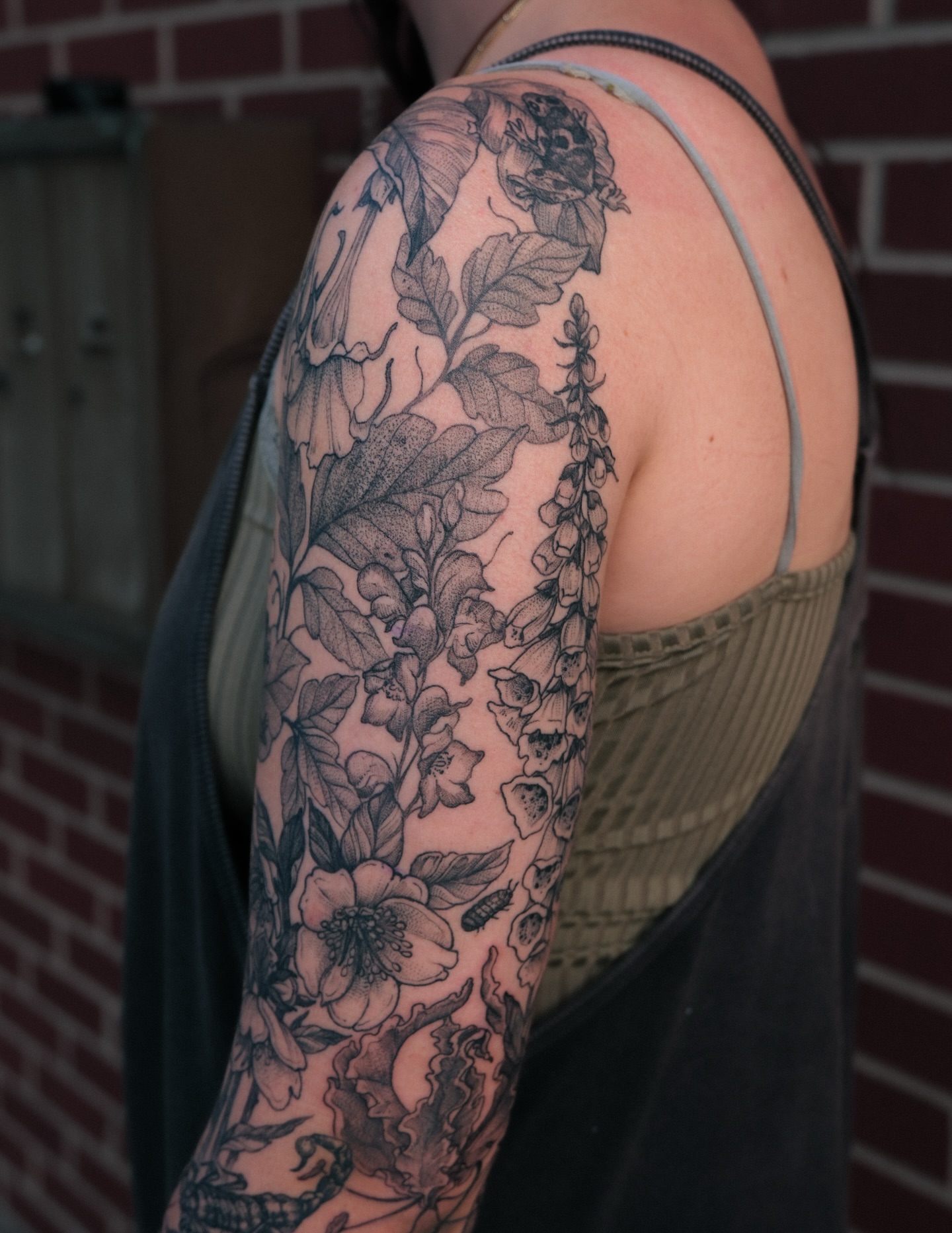 Floral bouquet black and grey tattoo on the upper arm by Renee (Koi) Vance
