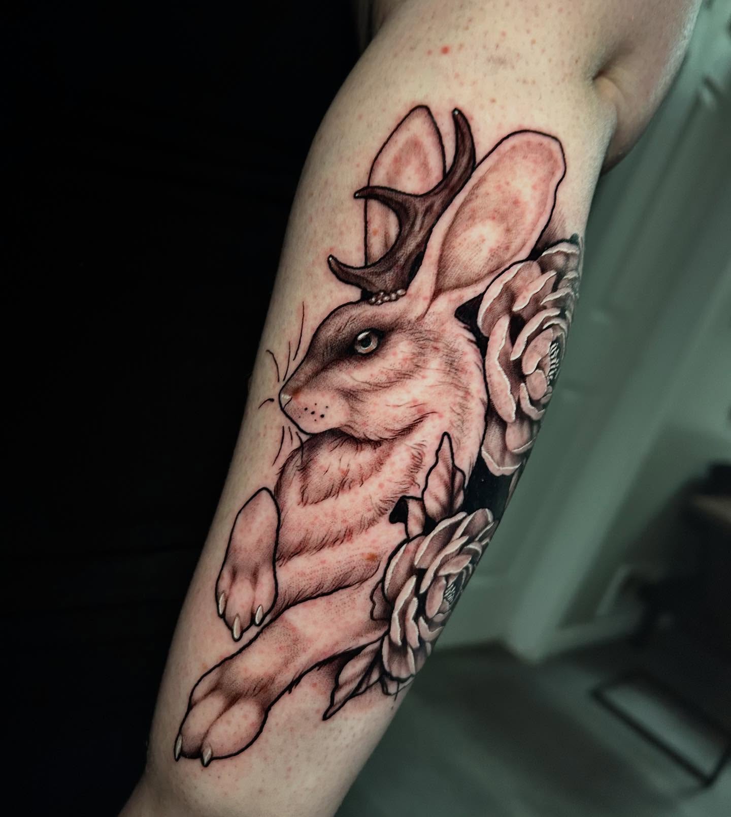 Deer and flowers realism tattoo on the forearm by Adrian Michigan Tattoo Artist