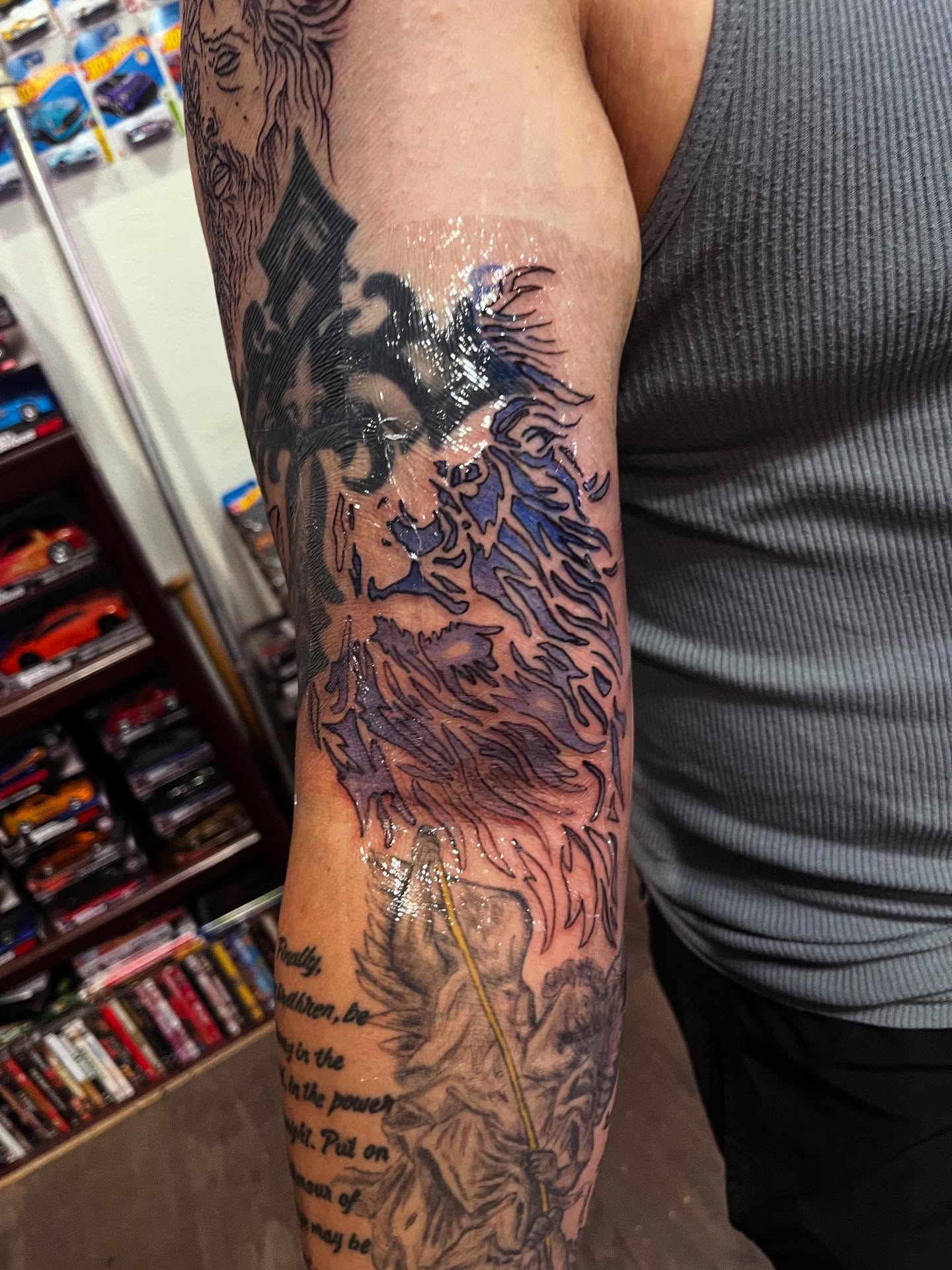 Lion and flames American traditional tattoo on the forearm by Anna DeLuna