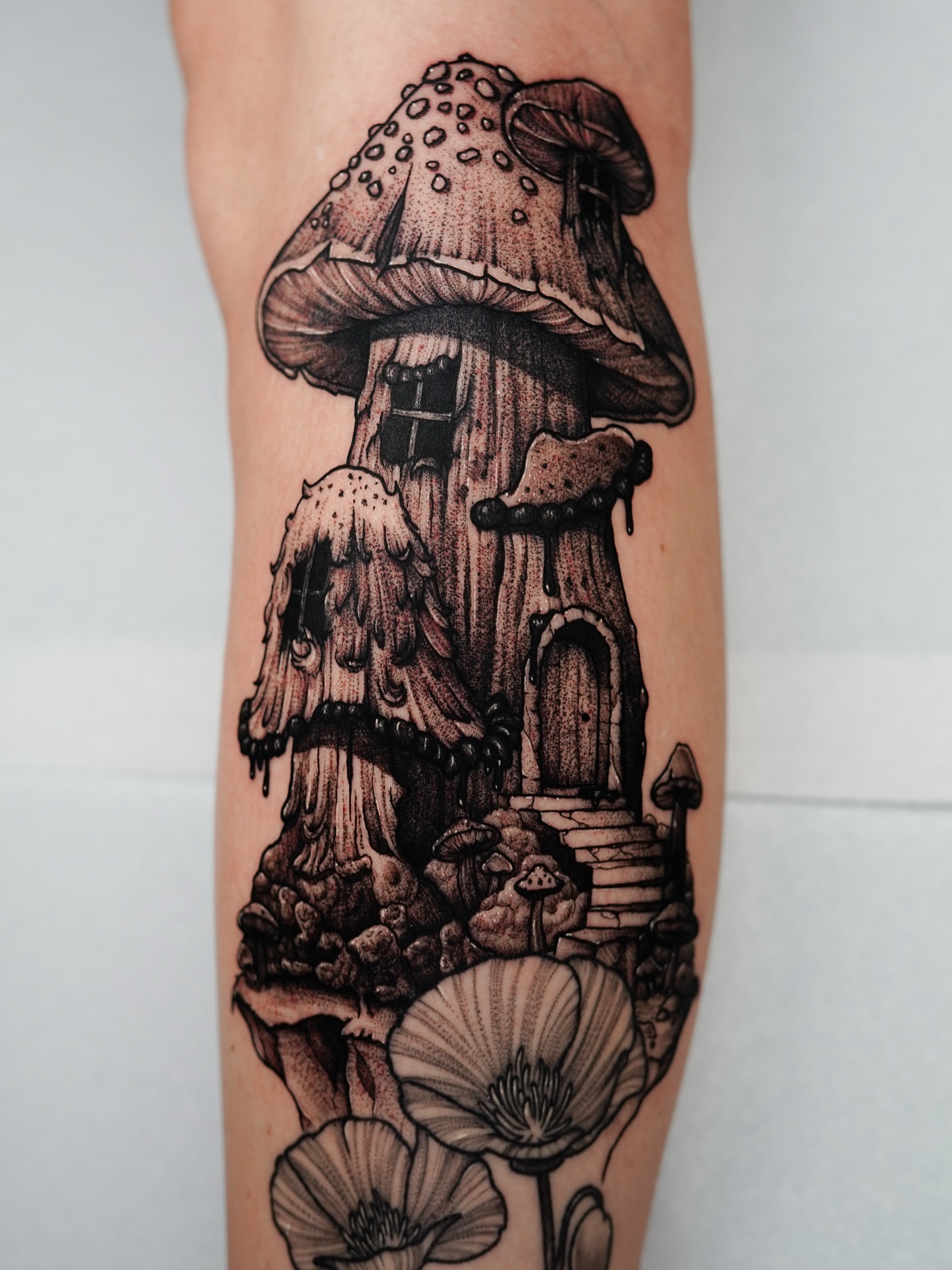 Mushroom house dotwork tattoo on the forearm by Tony Murray