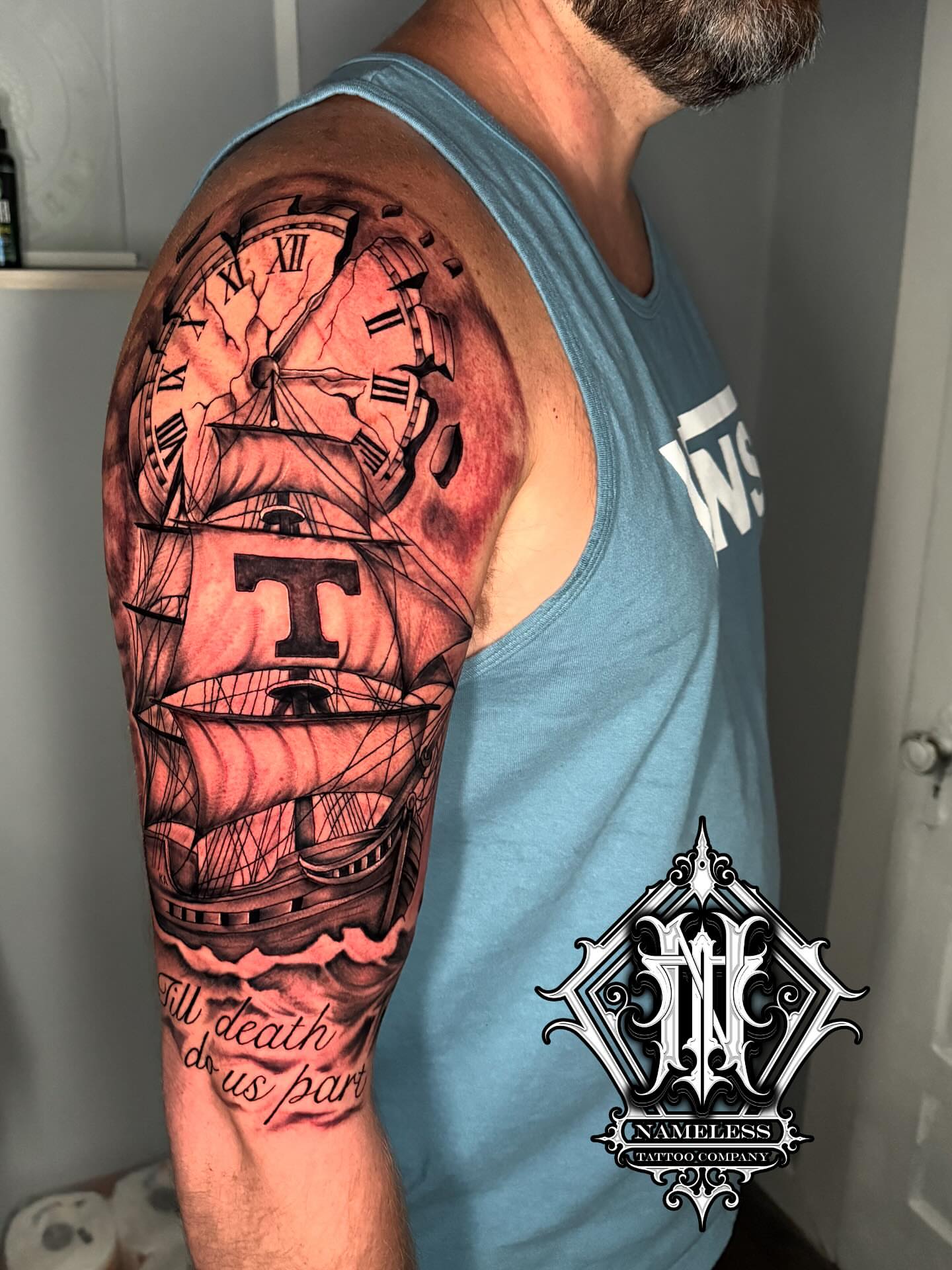 Ship and clock realism tattoo on the upper arm by AJ