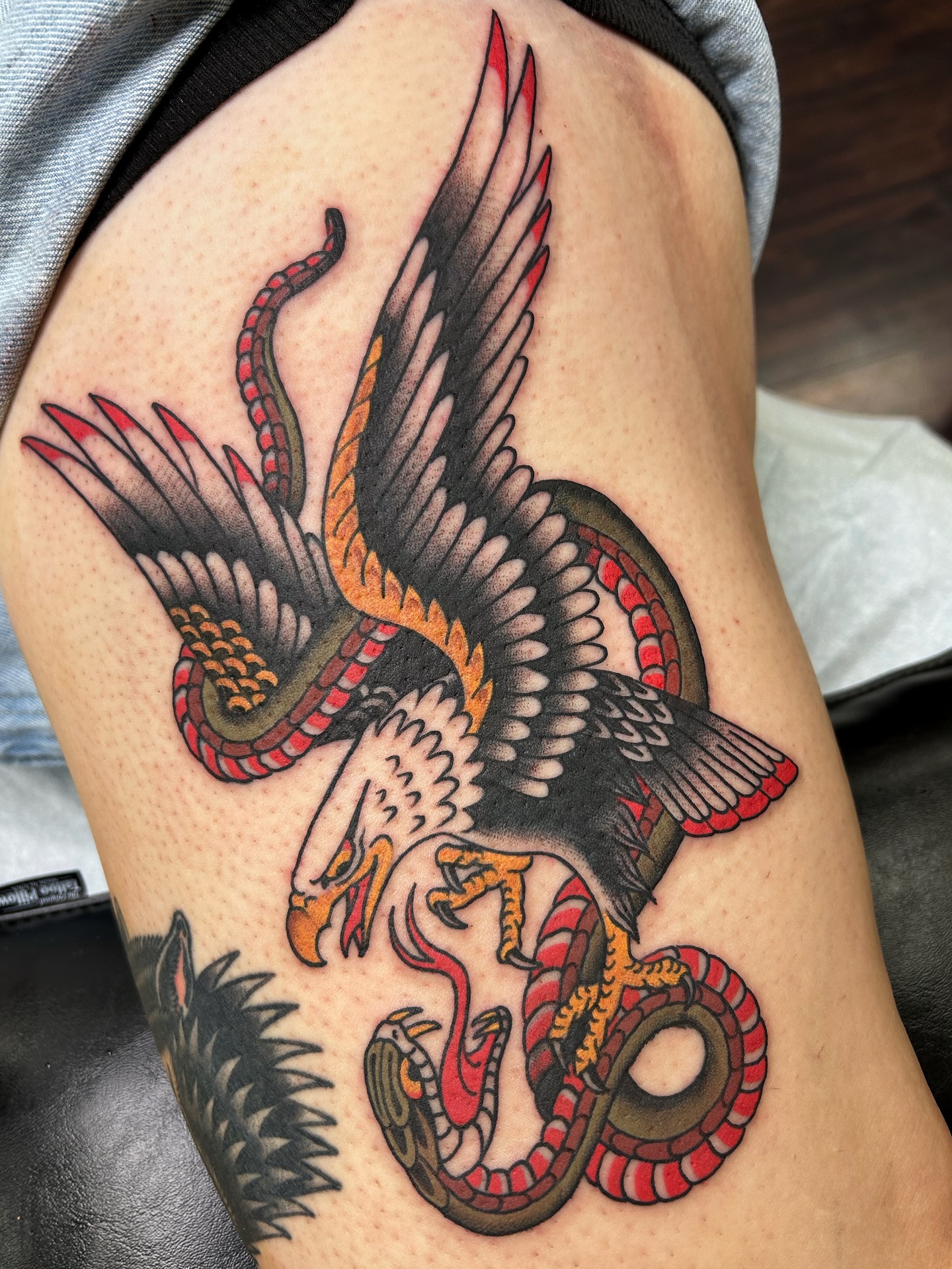 Eagle and snake American traditional tattoo on the thigh by Jade McKenzie, Temecula, California